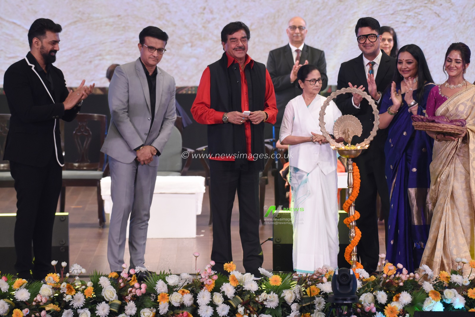 Former Indian cricket team captain Sourav Ganguly , left to 2nd, Chief Minister of West Bengal state Mamata Banerjee, fourth left white dress,  Bollywood actor and lawmaker Shatrughan Sinha, left to 3rd, Actor and MP Dev,June Malia, attend the lamp lighting ceremony during the inauguration of the 30th Kolkata International Film Festival in Kolkata, India,Wednesday, December 4,2024. The festival will continue till Dec. 11.Pictures by Debajyoti Chakraborty.(Photo: Debajyoti Chakraborty/News Images)