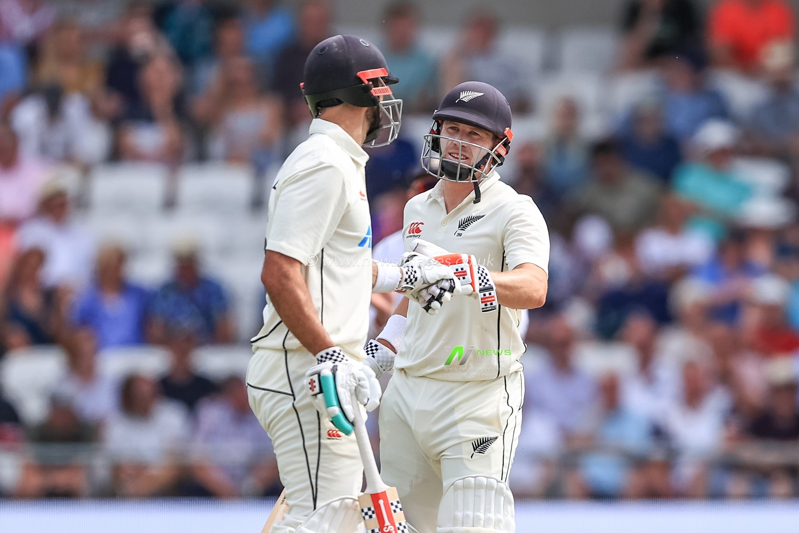 Henry Nicholls of New Zealand (R) congratulates Daryl Mitchell of New Zealand (L) after he hits a six
