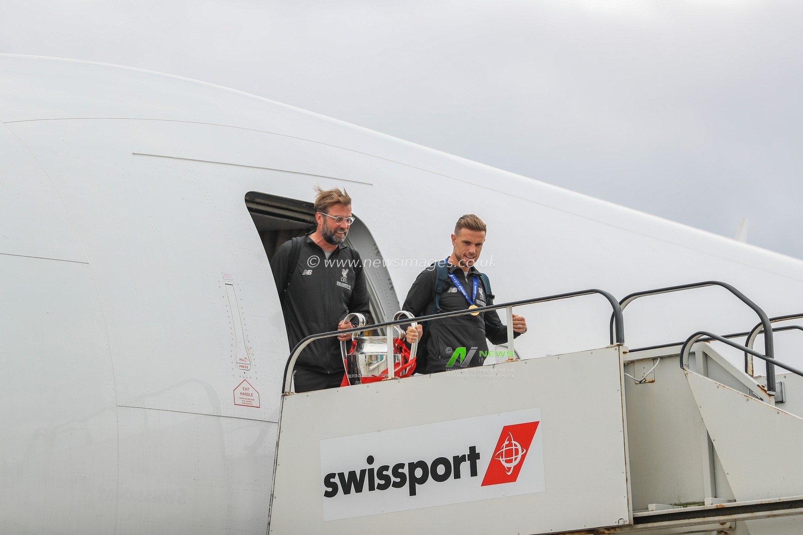 2nd June 2019 , Liverpool, England; UEFA Champions League, Liverpool FC Champions League winners celebrations and open top bus parade ; Liverpool manager Jurgen Klopp and Jordan Henderson leave the aeroplane carrying the European Cup


Credit: Mark Cosgrove/News Images
