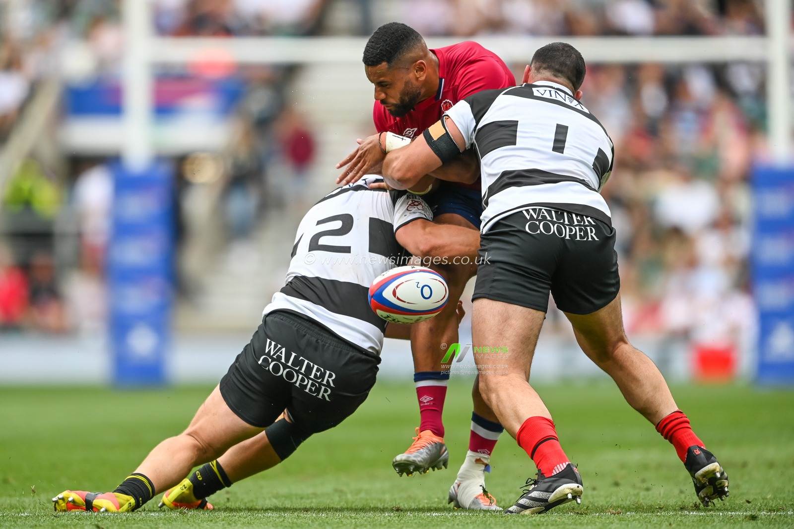 Joe Cokanasiga of England loses the ball in the tackle from Jean-Baptiste Gros and Pierre Bourgarit of Barbarians
