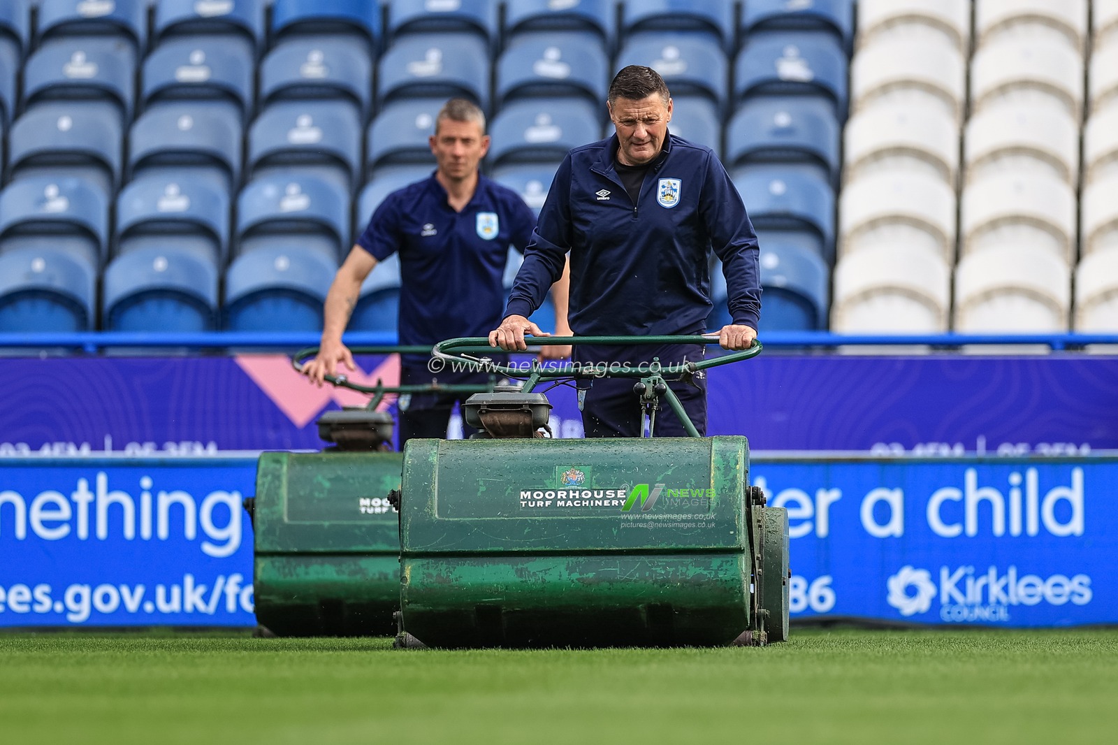 Huddersfield Town ground staff making a final cut to the turf