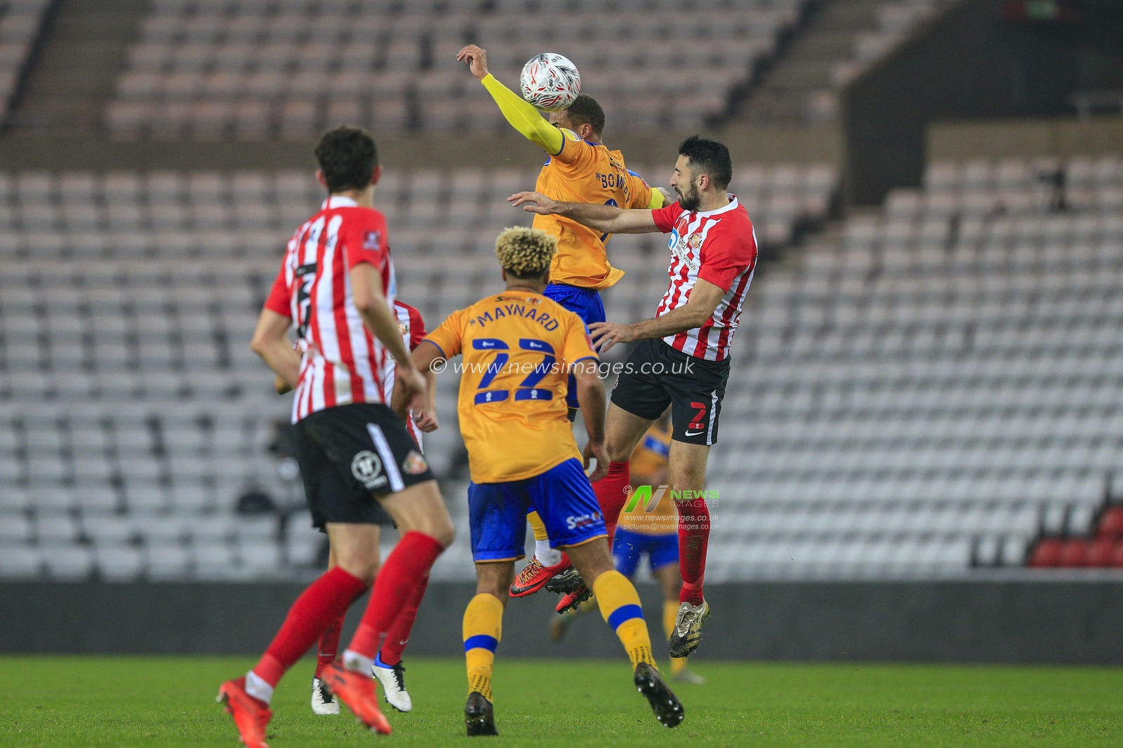 Jordan Bowery #9 of Mansfield Town in an aerial challenge with Conor McLaughlin #2 of Sunderland