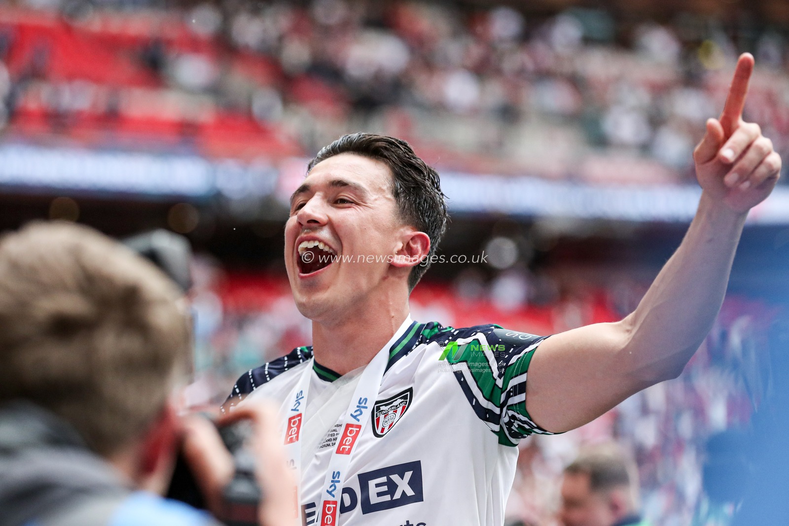 Dan Neil of Sunderland celebrates getting promoted back to the Premier League after the Sky Bet Championship Playoff Final match Sheffield United vs Sunderland at Wembley Stadium, London, United Kingdom, 24th May 2025

(Photo by Izzy Poles/News Images)