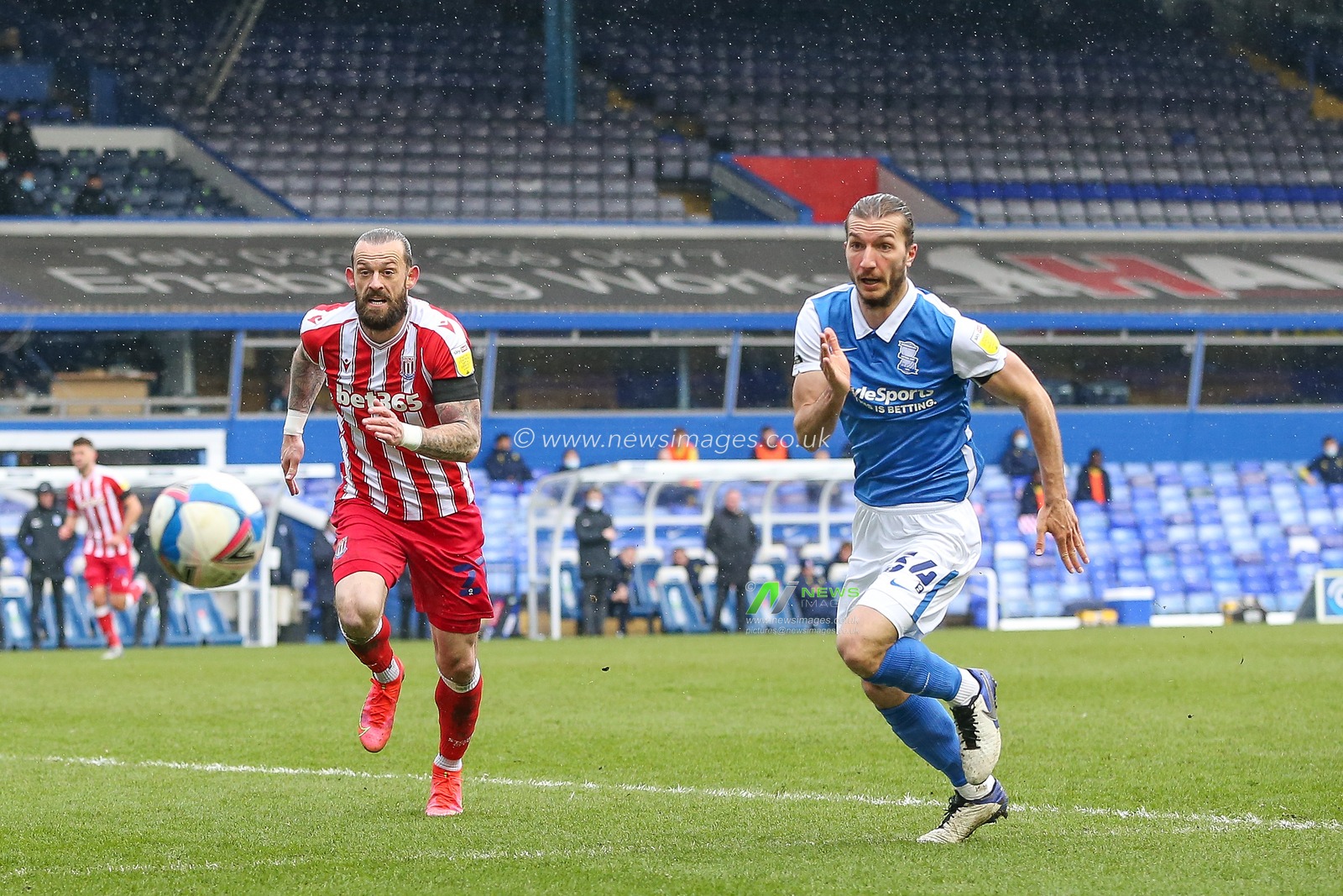 Ivan Sunjic #34 of Birmingham City and Steven Fletcher #21 of Stoke City chase down the ball