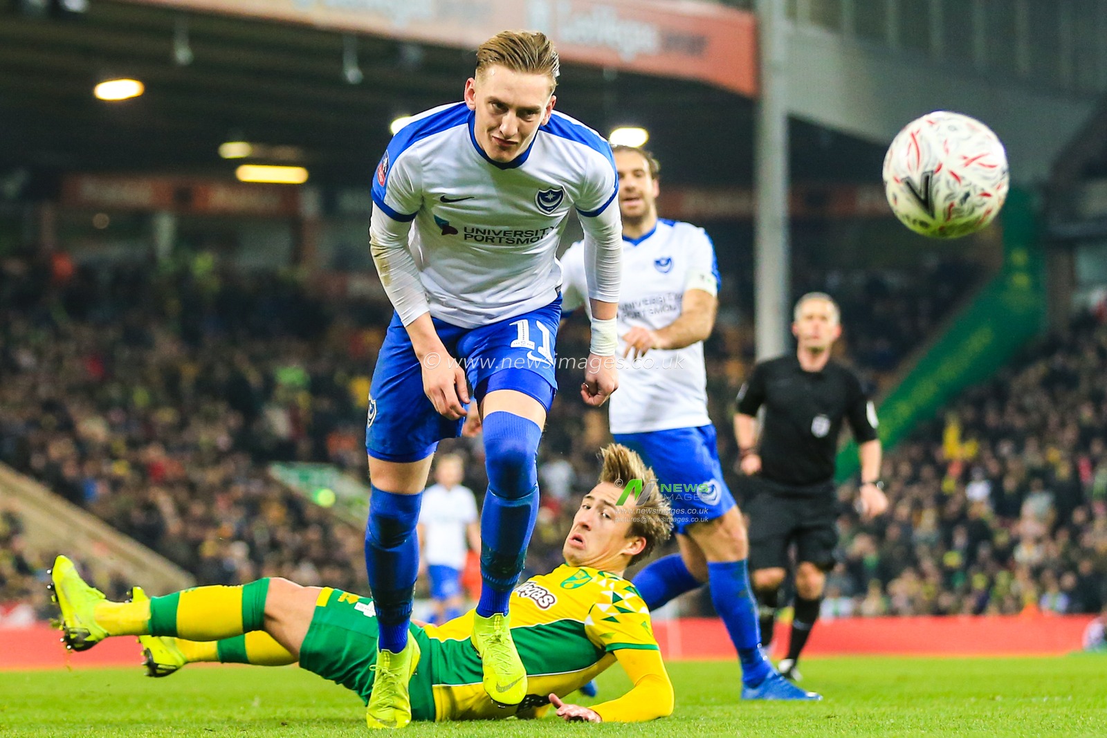 5th January 2019, Carrow Road, Norfolk, England; The Emirates FA Cup, 3rd Round, Norwich City vs Portsmouth ;  Ronan Curtis (11) of Portsmouth eyes the ball after being challenged by Felix Passlack (24) of Norwich City

Credit: Georgie Kerr/News Images

English Football League images are subject to DataCo Licence