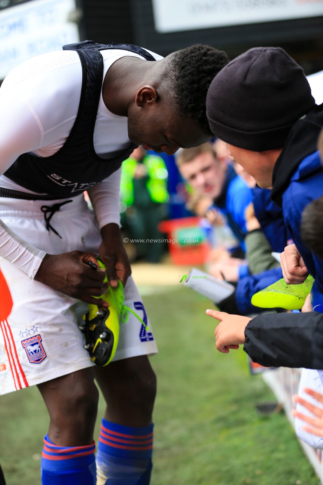 5th May 2019, Portman Road, Ipswich, England; Sky Bet Championship Ipswich Town vs Leeds United  ; Aristote Nsiala (22) of Ipswich signs his boots for a young fan

Credit: Georgie Kerr/News Images,

English Football League images are subject to DataCo Licence