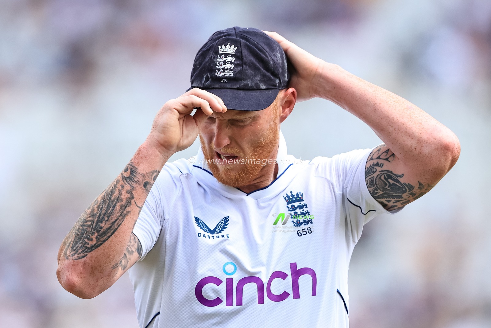 Ben Stokes of England puts his hat on