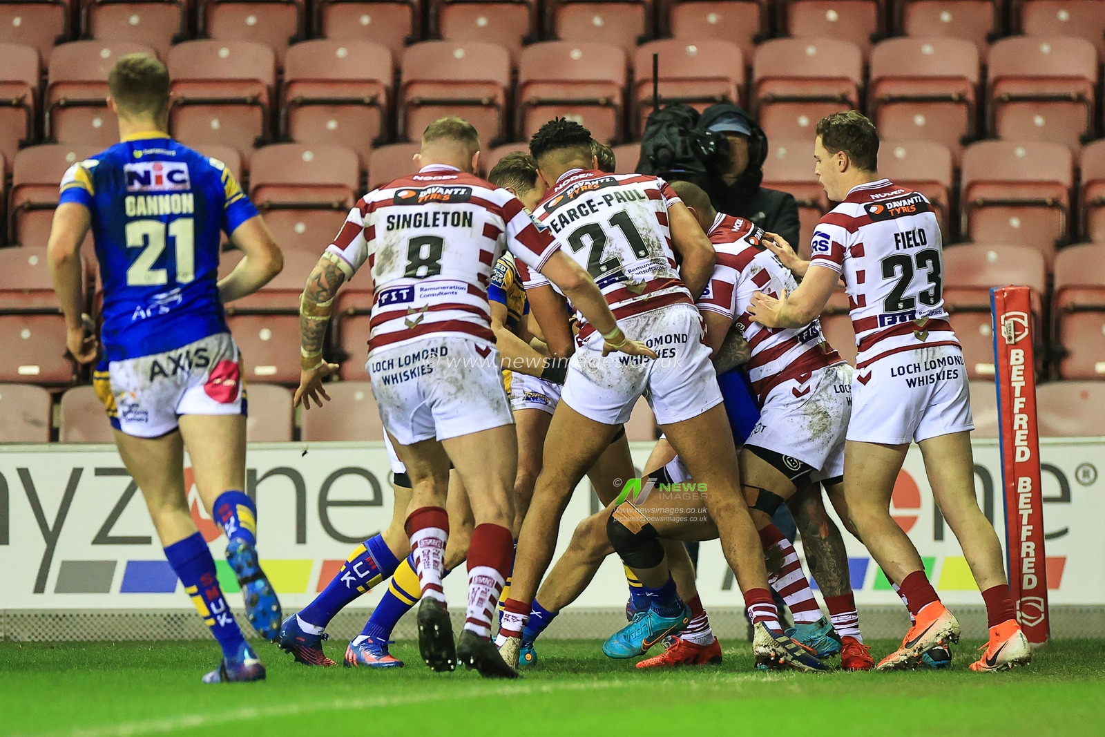 Ash Handley #5 of Leeds Rhinos is gang tackled by Wigan Warriors