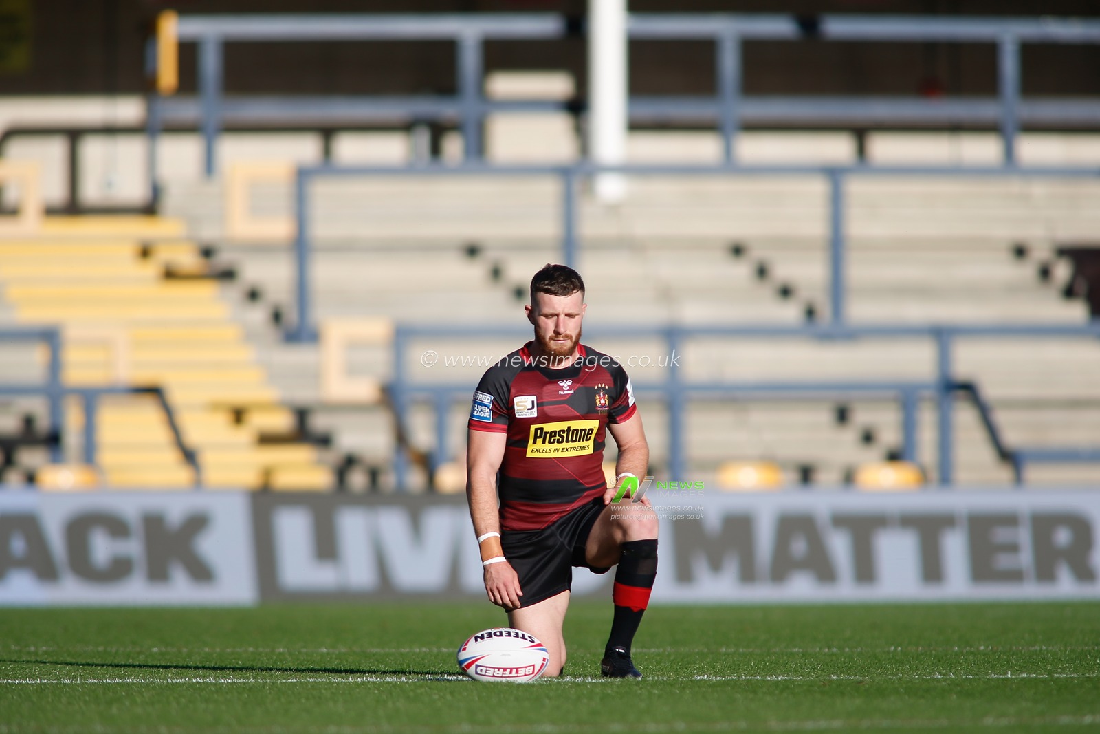 Jacksons Hastings (31) of Wigan Warriors takes a knee in support of Black Lives Matter ahead of the game.