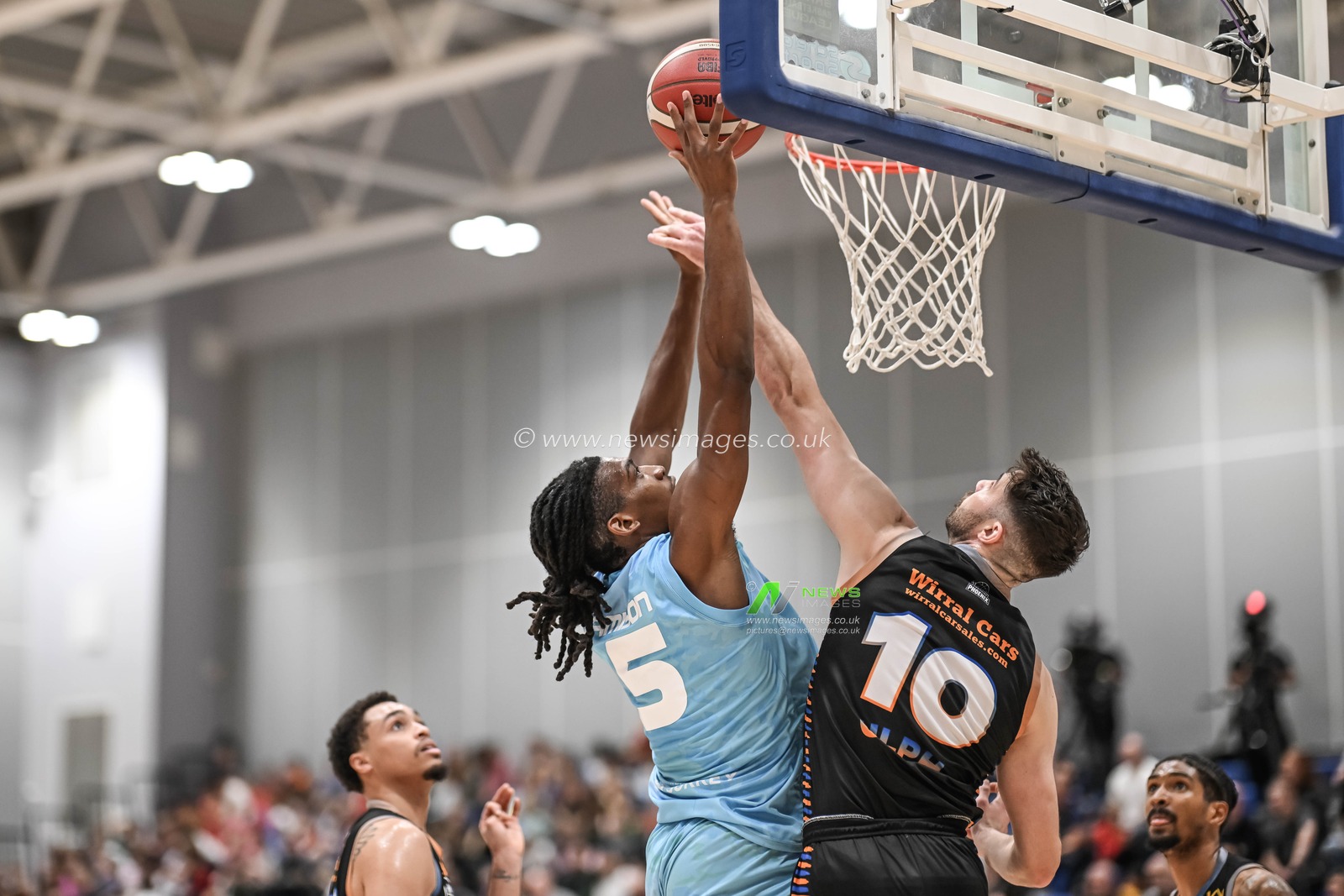 Saiquan Jamison of Surrey Scorchers attacks the basket despite pressure from David Ulph of Cheshire Phoenix during the British Basketball Championship match Cheshire Phoenix vs Surrey Scorchers at Ellesmere Port Sports Village, Ellesmere Port, United Kingdom, 19th November 2023

(Photo by Craig Thomas/News Images)