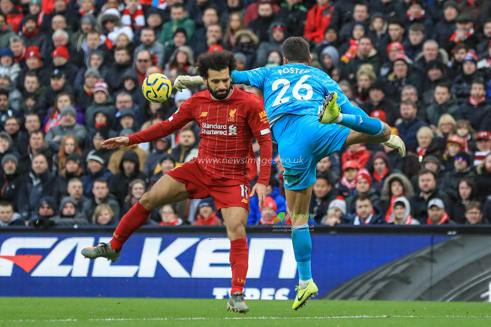14th December 2019, Anfield, Liverpool, England; Premier League, Liverpool v Watford :  Ben Foster (26) of Watford punches the ball clear as Mohamed Salah (11) of Liverpool pressures 

Credit: Mark Cosgrove/News Images