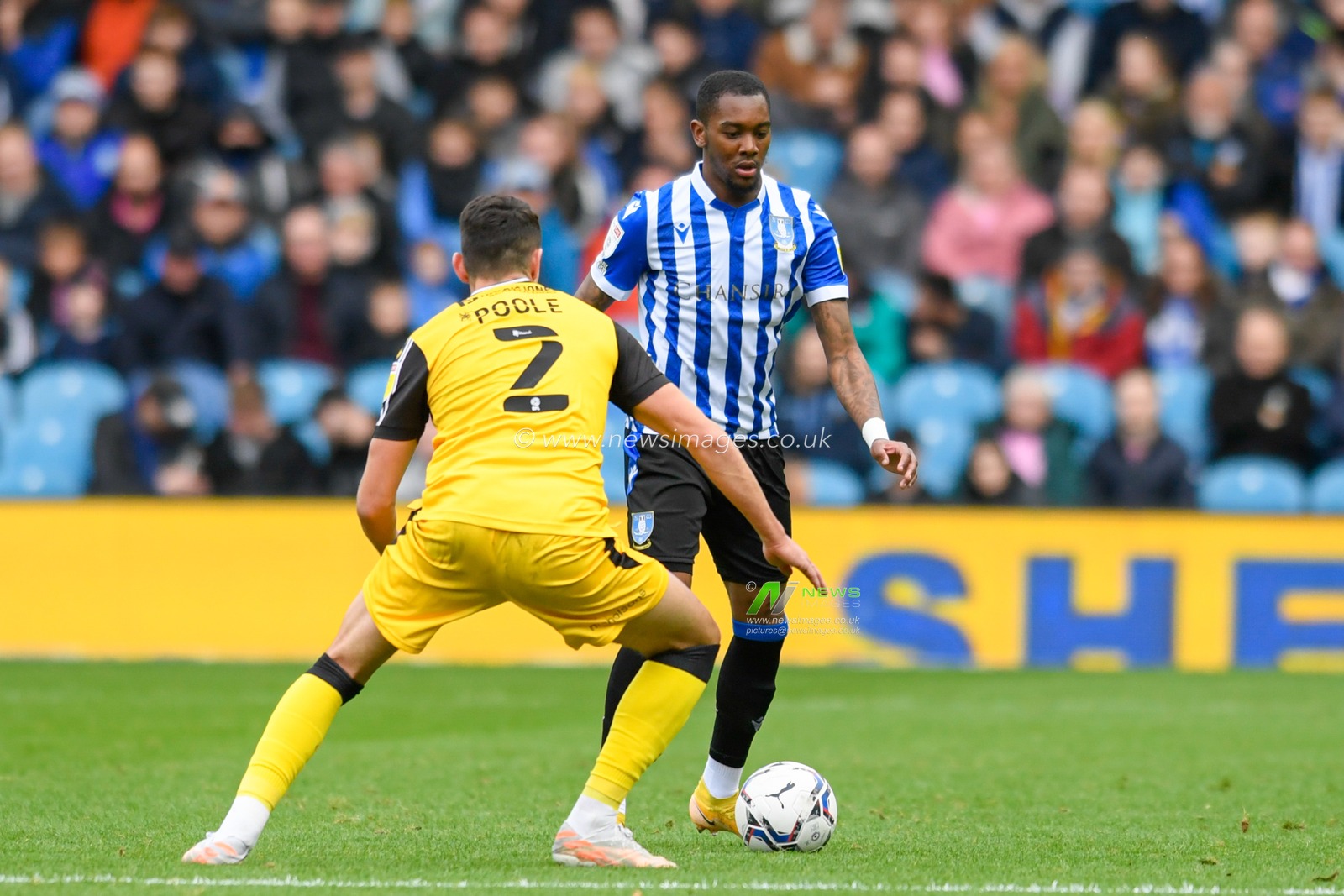 Jaden Brown #3 of Sheffield Wednesday looks for a way past Regan Poole #2 of Lincoln City