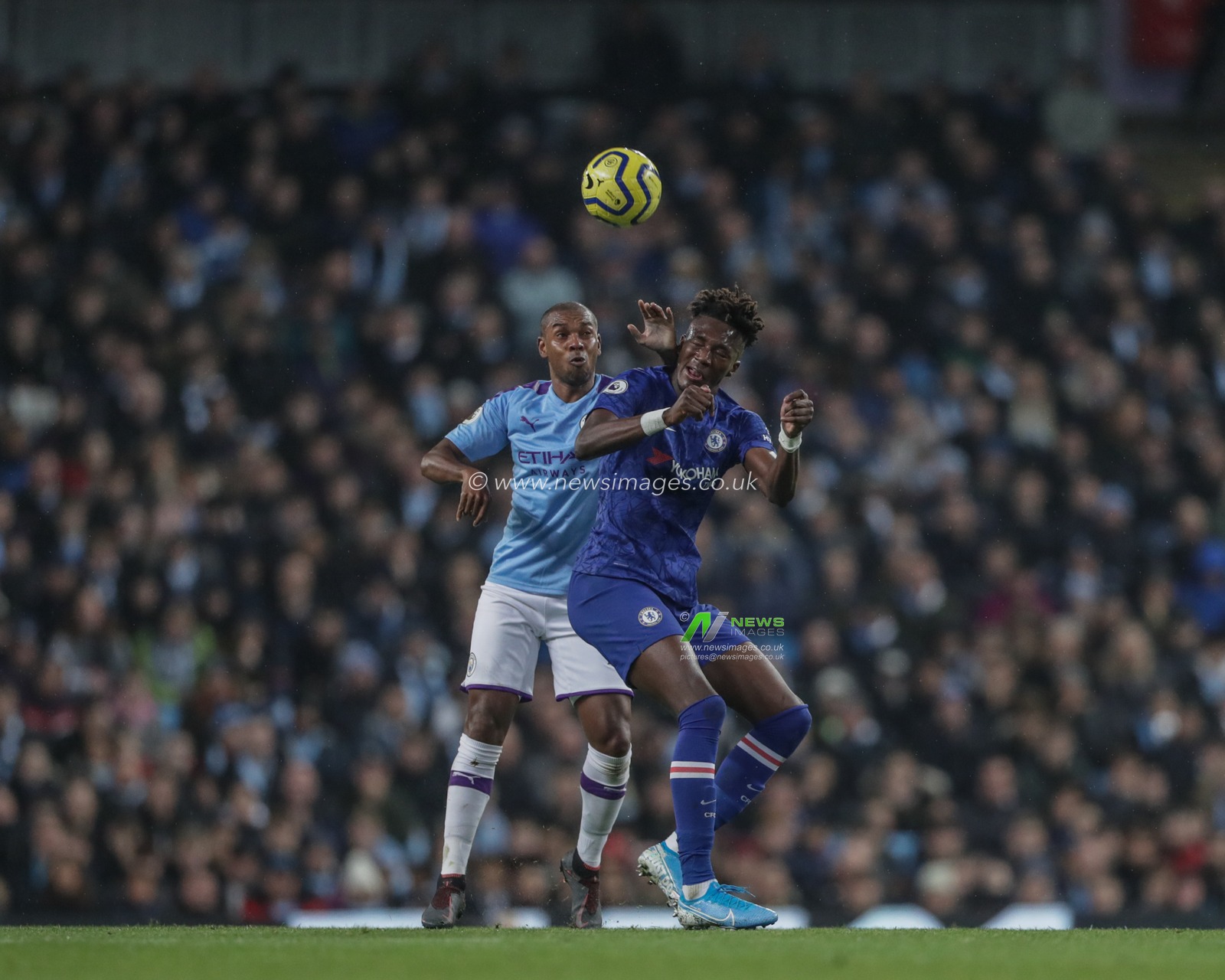23rd November 2019, Etihad Stadium, Manchester, England; Premier League, Manchester City v Chelsea : Fernandinho (25) of Manchester City and Tammy Abraham (9) of Chelsea dual for the ball 

Credit: Mark Cosgrove/News Images