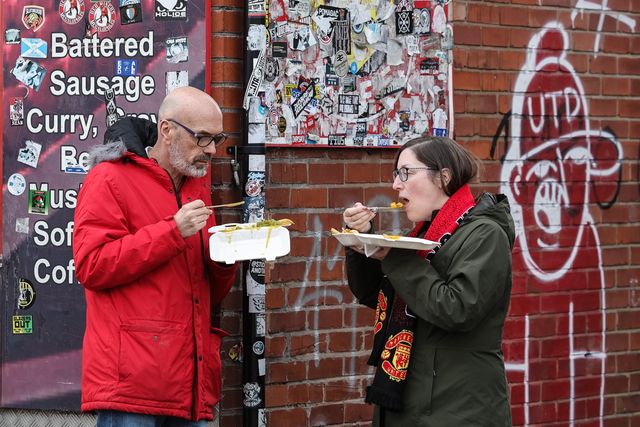 Fans grab a bite to eat on route to Old Trafford during the Premier League match Manchester United vs Crystal Palace at Old Trafford, Manchester, United Kingdom on 01 March 2026

(Photo by Mark Cosgrove/News Images)