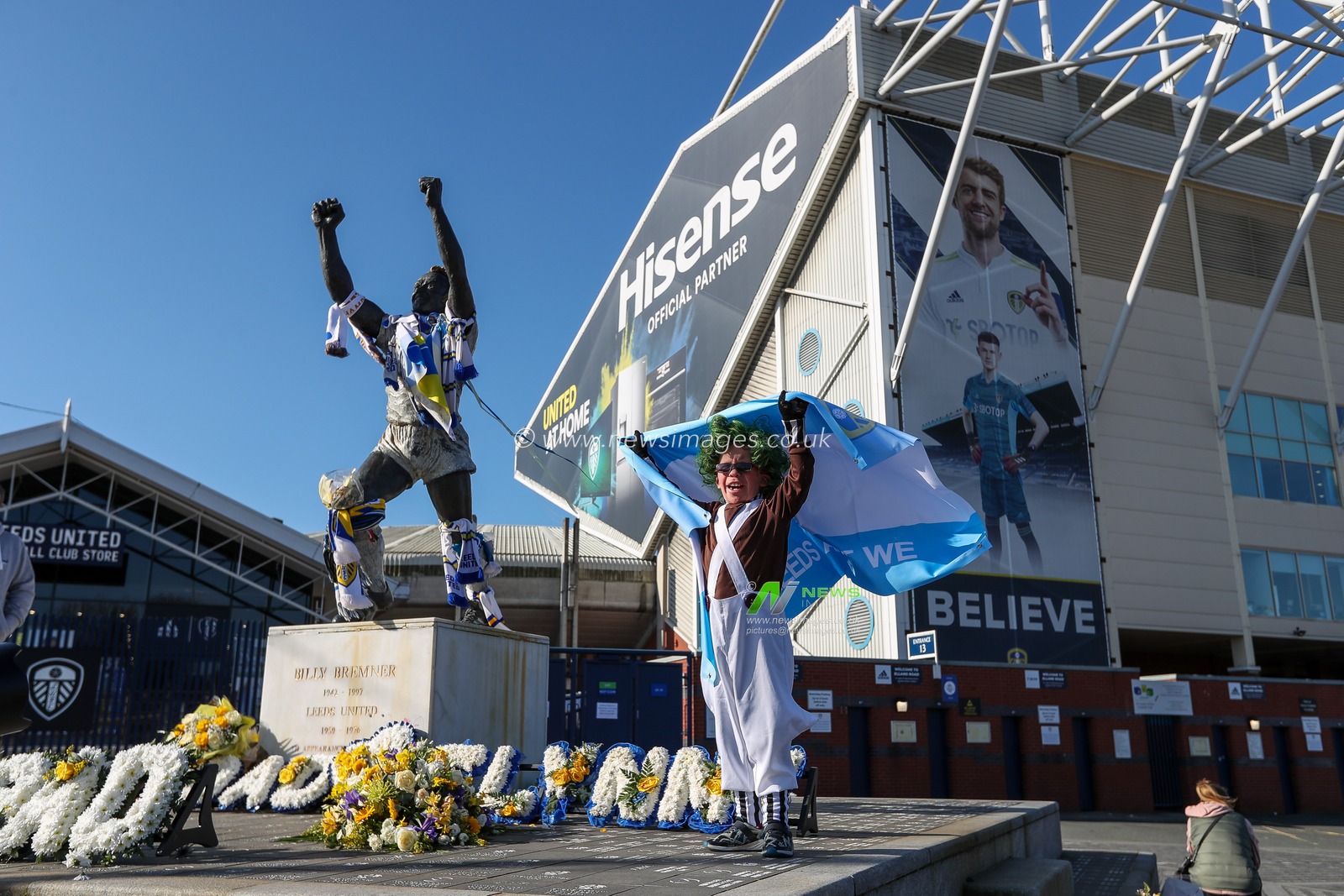 A young Leeds United supporter holds up the Argentina flag outside Elland Road Stadium in support of Marcelo Bielsa after he was sacked by the club this morning