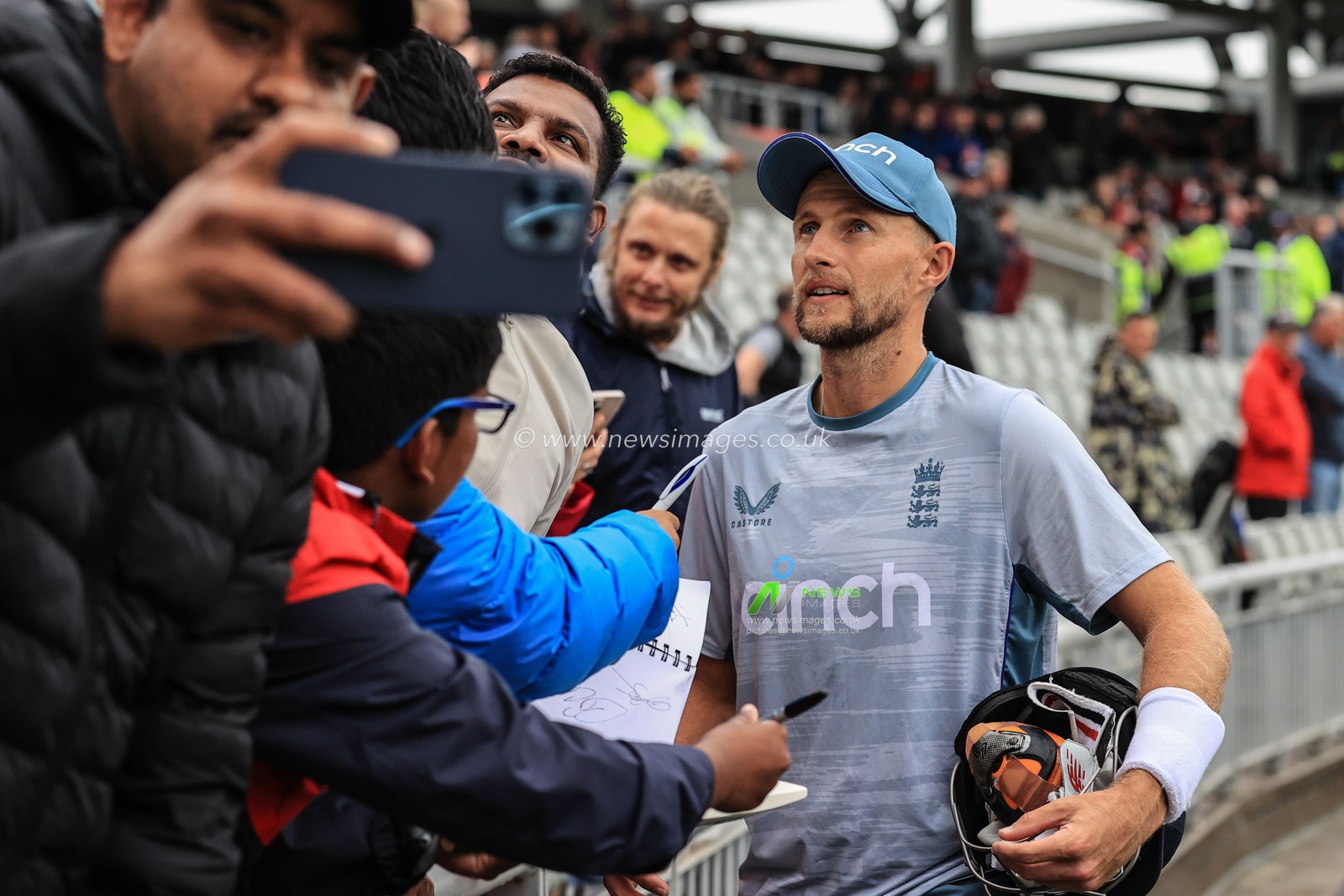 Joe Root of England signs autographs for fans