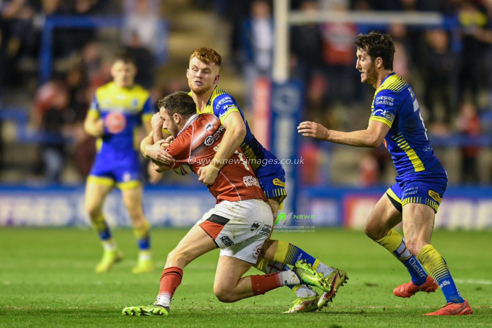 Ryan Brierley #1 of Salford Red Devils is tackled by Ellis Longstaff #24 of Warrington Wolves