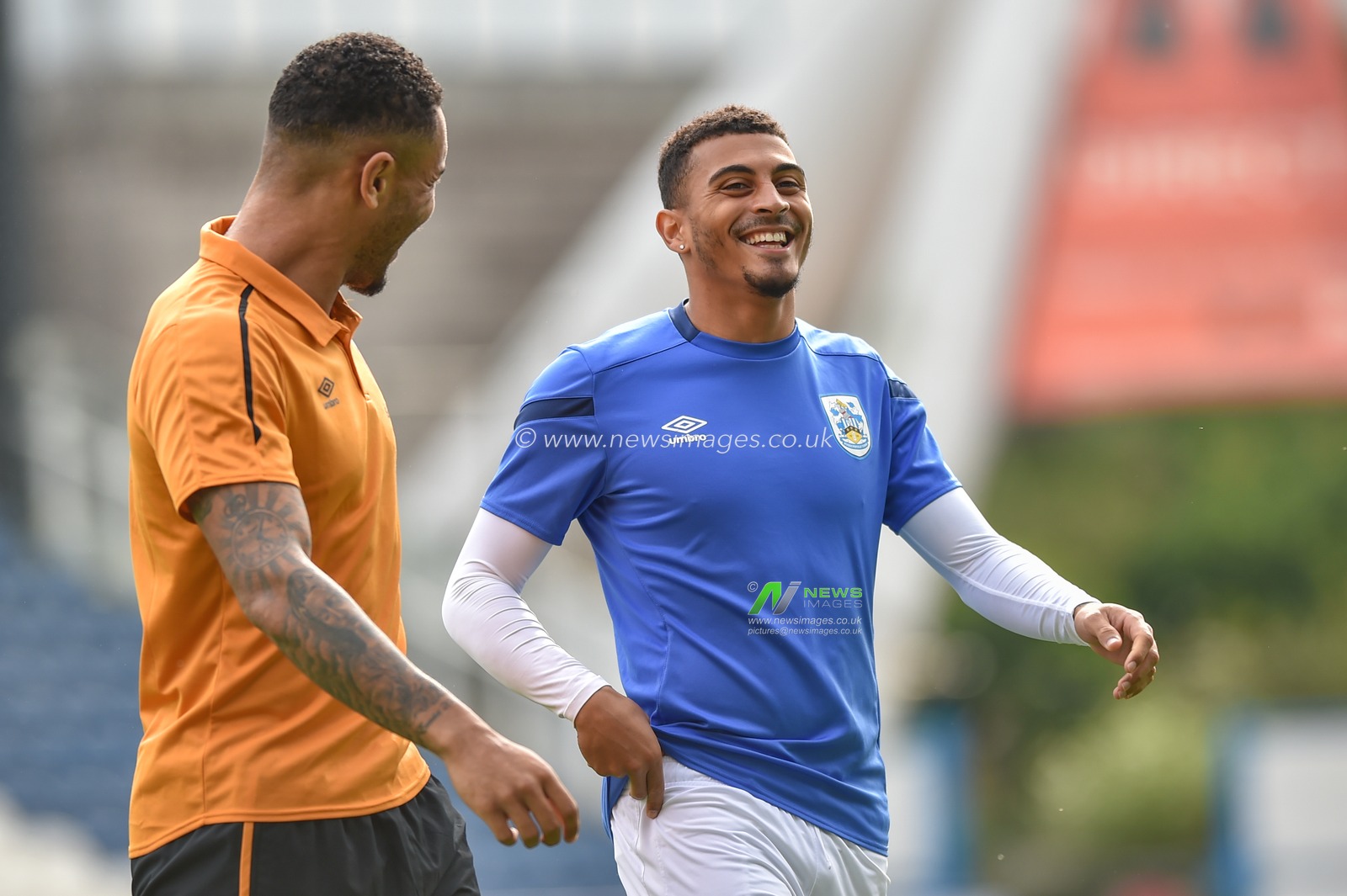 5th October 2019, John Smith's Stadium, Huddersfield, England; Sky Bet Championship, Huddersfield Town v Hull City :Josh Magennis (27) of Hull City and Karlan Grant (16) of Huddersfield Town share alike prior to kick off.
Credit: Dean Williams/News Images