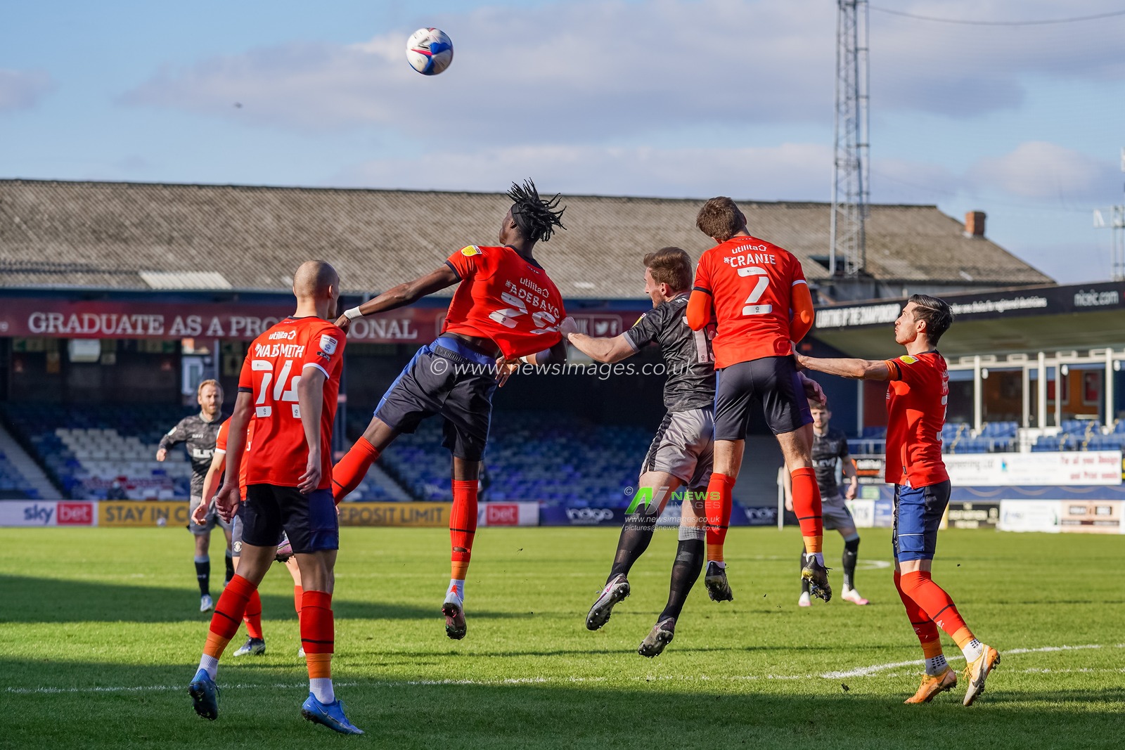 Tom Lees #15 of Sheffield Wednesday pulls the shirt of Elijah Adebayo #29 of Luton Town