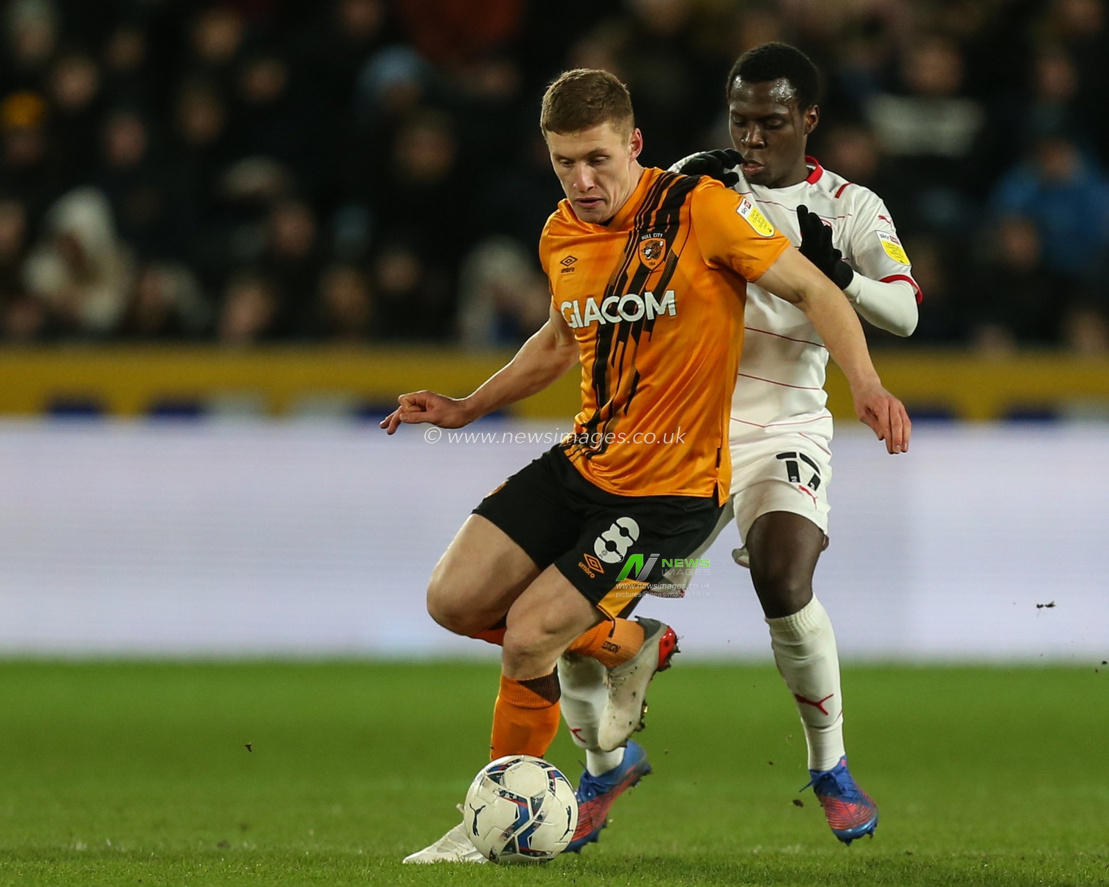Greg Docherty #8 of Hull City defends the ball from Claudio Gomes #17 of Barnsley