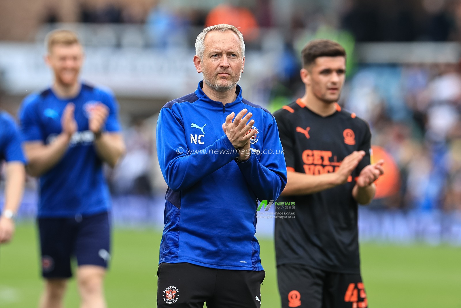 Neil Critchley head coach of Blackpool applauds the traveling fans
