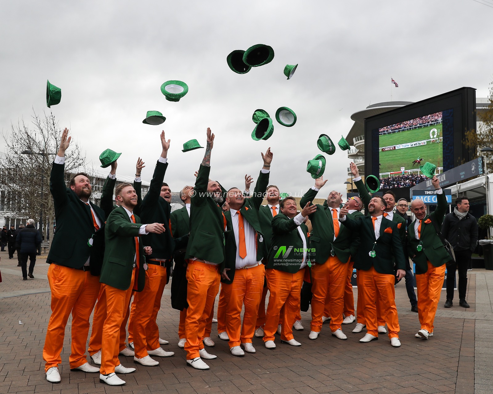 Racegoers dressed in orange and green pose for a photo as they arrive for the Cheltenham Festival 2025 St Patrickâ€™s Thursday at Cheltenham Racecourse, Cheltenham, United Kingdom, 13th March 2025

(Photo by Gareth Evans/News Images)