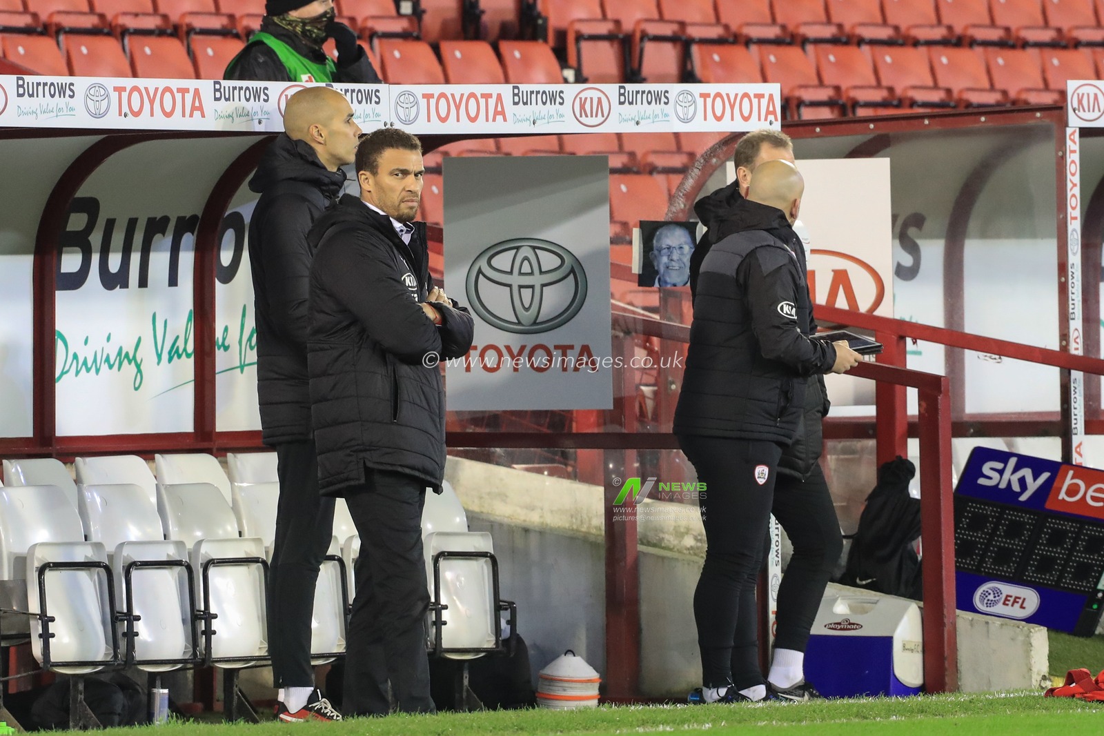 Valerien Ismael manager of Barnsley in the dug-out and a picture of the late and great Norman Rimmington aka Rimmo and Mr Barnsley taped to the side