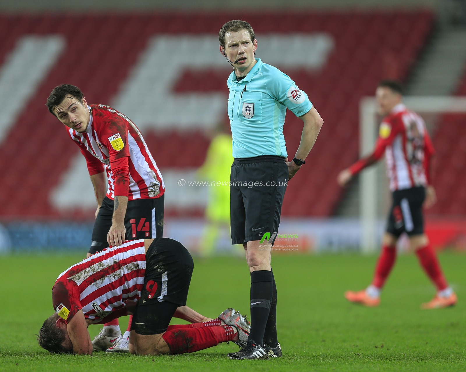 Josh Scowen #14 of Sunderland checks on Charlie Wyke #9 of Sunderland who took a knock following a challenge