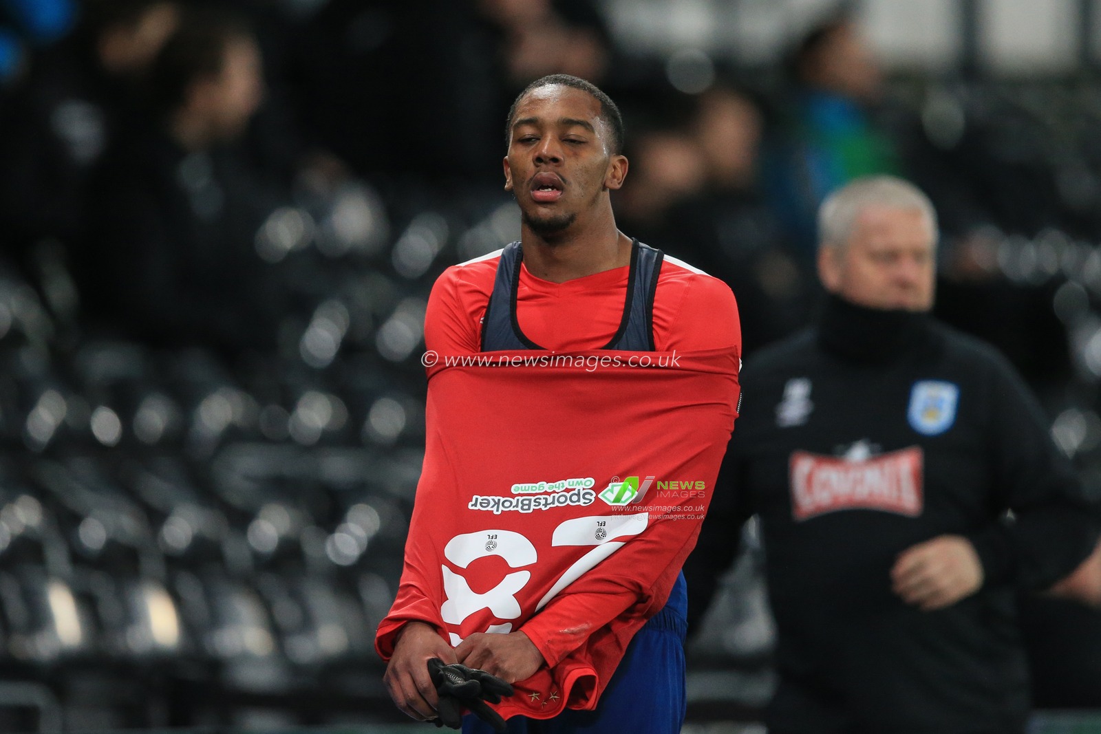 Jaden Brown #28 of Huddersfield Town walks back to the changing rooms after being sent off for two yellow cards followed by a red