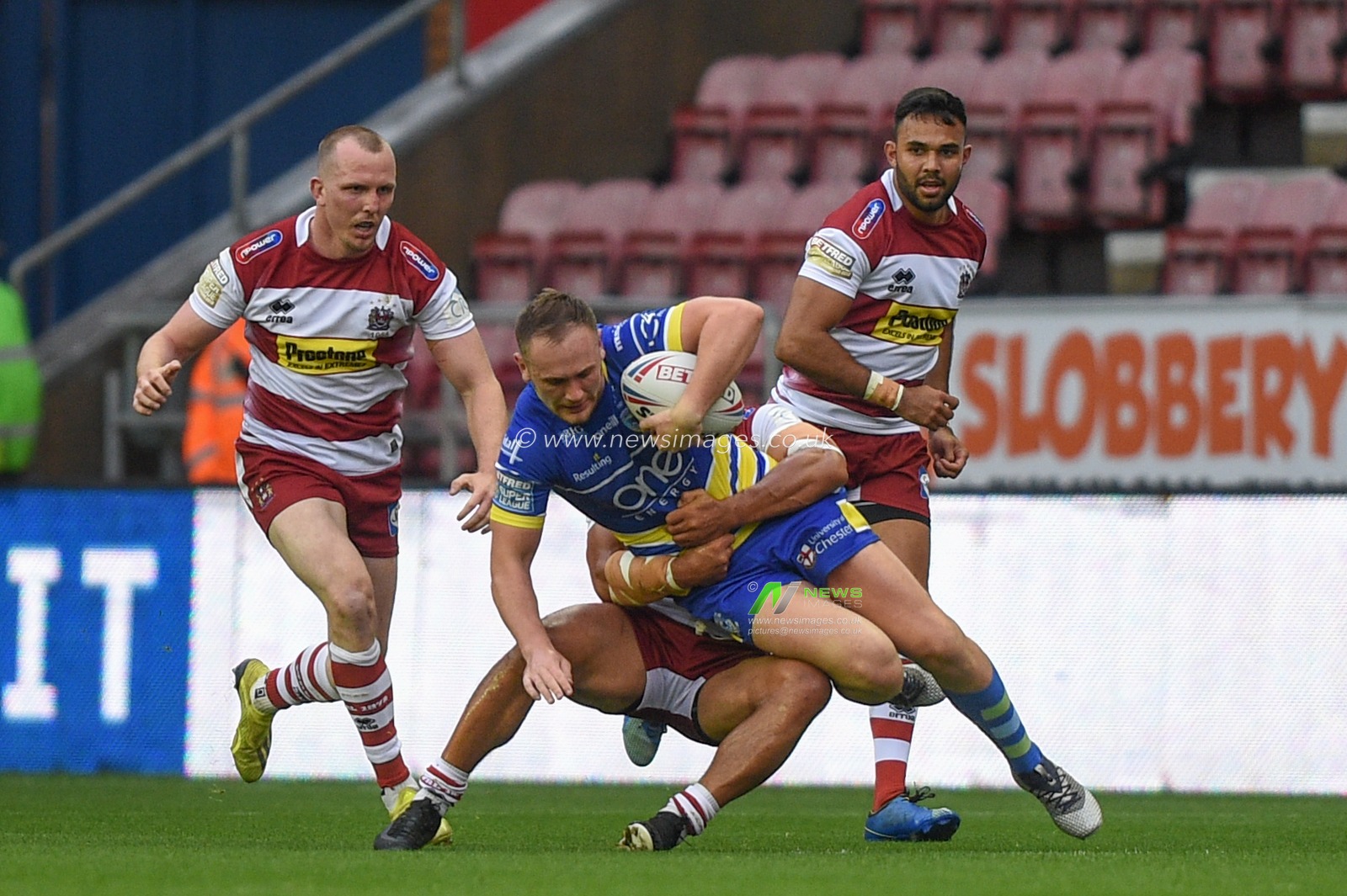 16th August 2019 , DW Stadium, Wigan, England;  Betfred Super League, Round 26, Wigan Warriors vs Warrington Wolves ; Ben Currie of Warrington Wolves is brought down 
By the wigan defence 

Credit: Richard Long/News Images