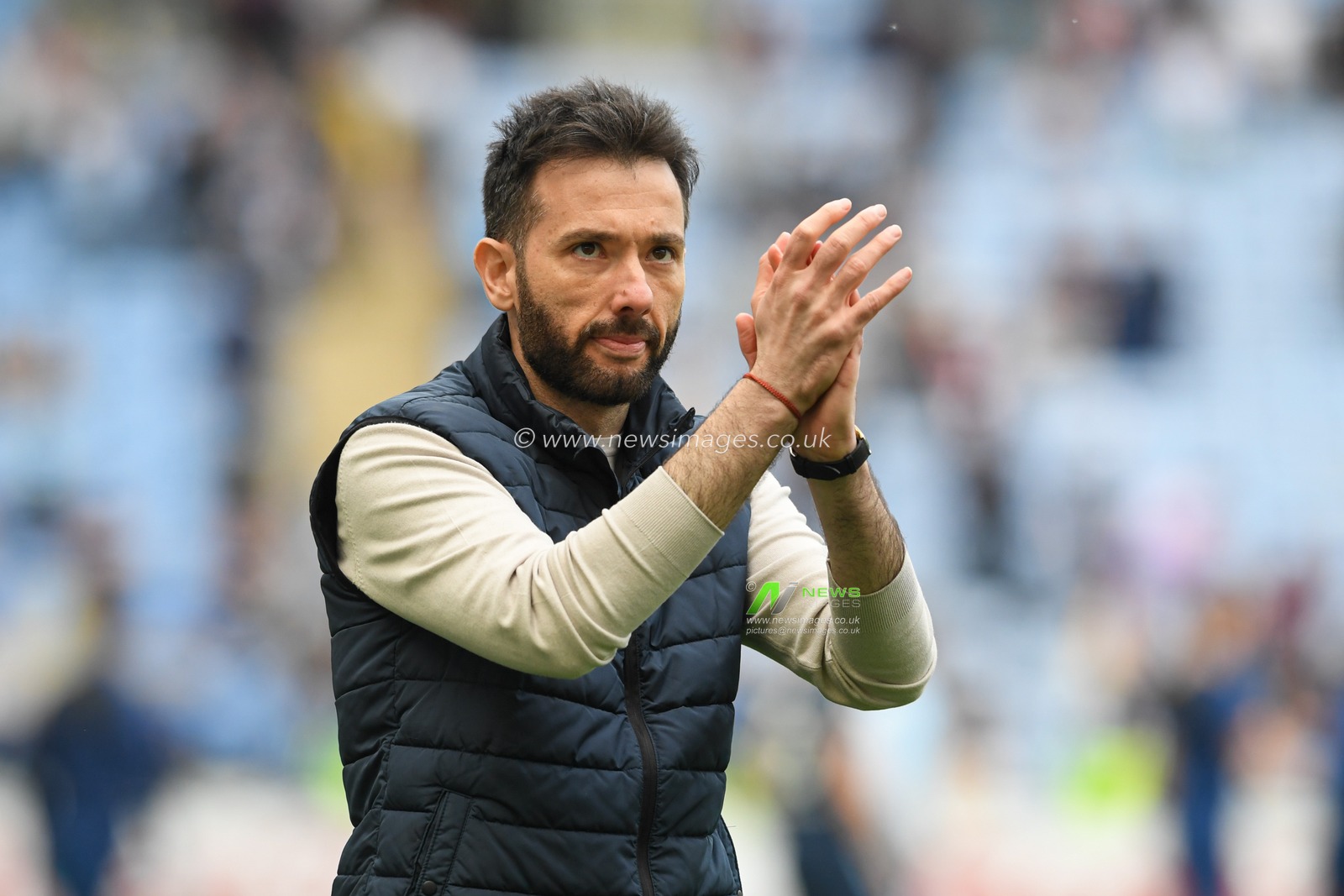Carlos Corberan manager of Huddersfield Town applauds the travelling supporters at the end of the game after his side beat Coventry City 1-2