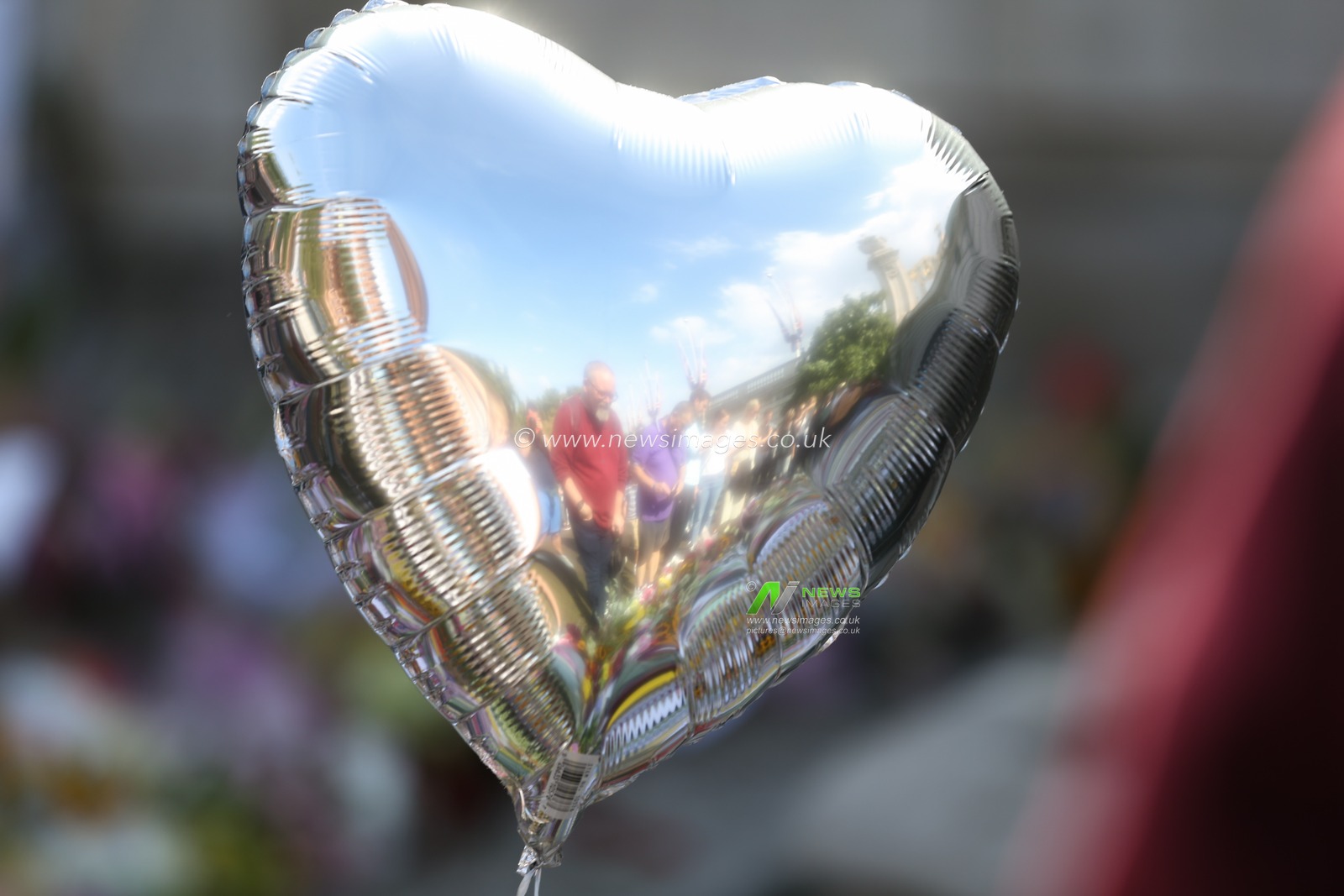 A reflection of the floral tributes in a balloon as mourners pay their respects on day 3 after the passing of Her Majesty The Queen at Buckingham Palace, London, United Kingdom, 11th September 2022

(Photo by Arron Gent/News Images)