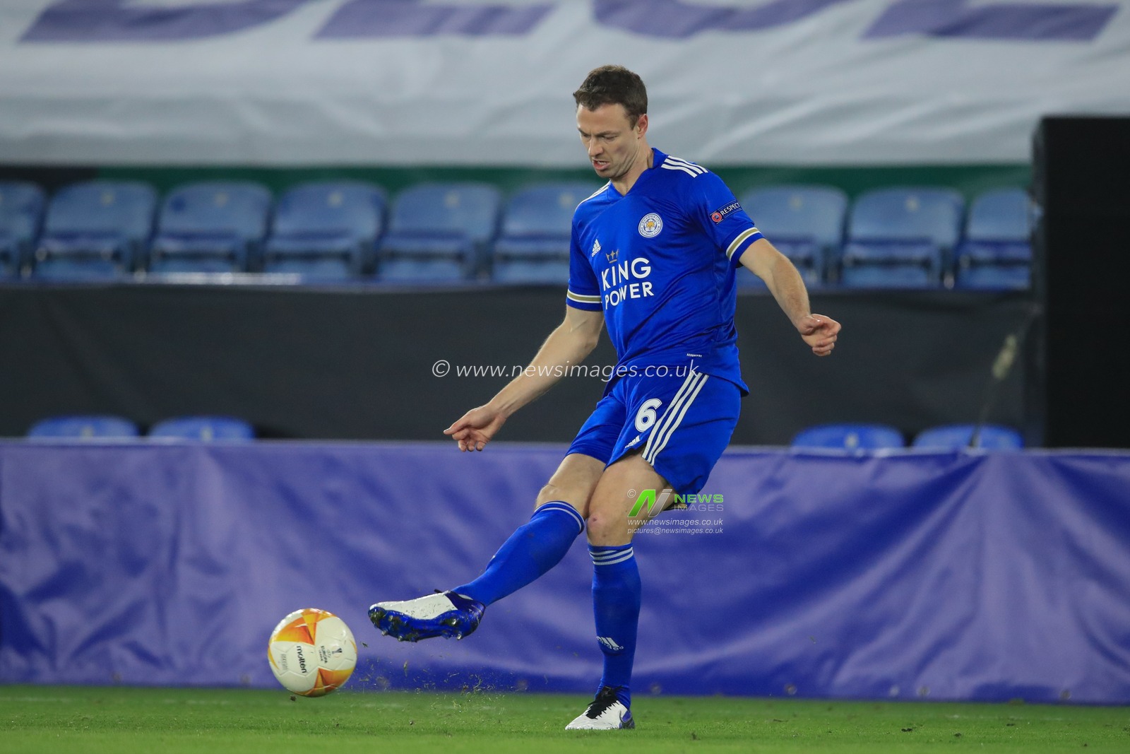 Jonny Evans #6 of Leicester City passes the ball back to Kasper Schmeichel #1 of Leicester City