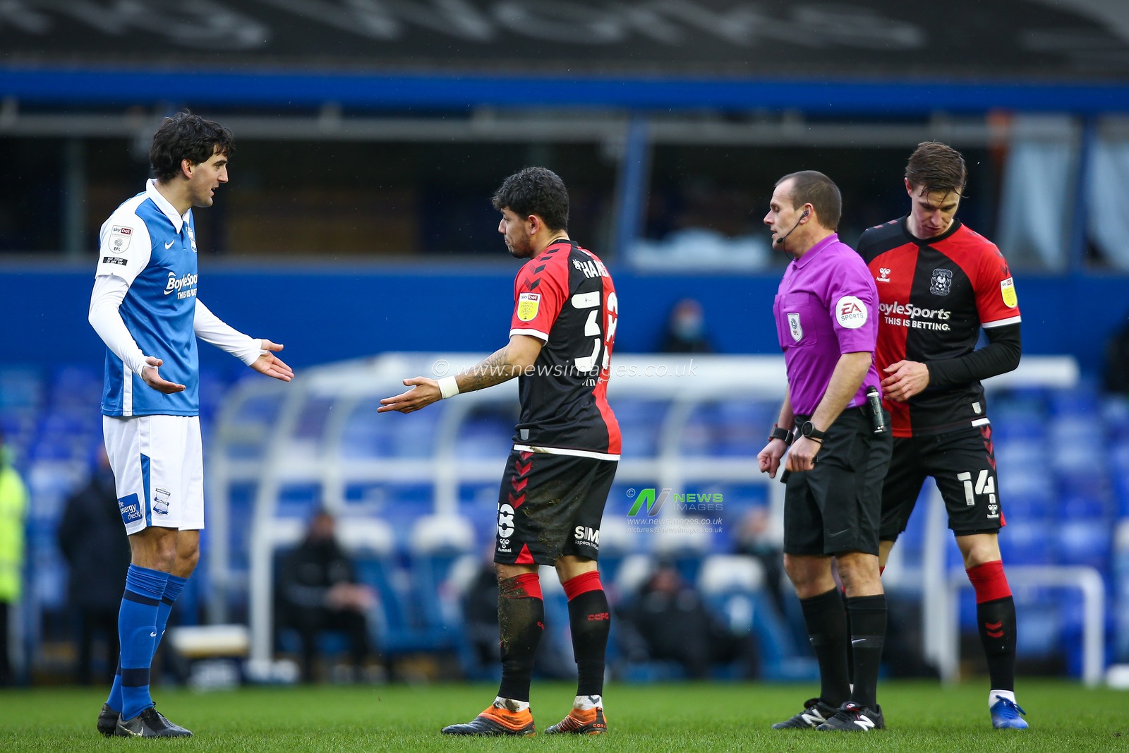 Mikel San Jose #19 of Birmingham City pleads his innocence with Gustavo Hamer #38 of Coventry City and Referee Geoff Eltringham