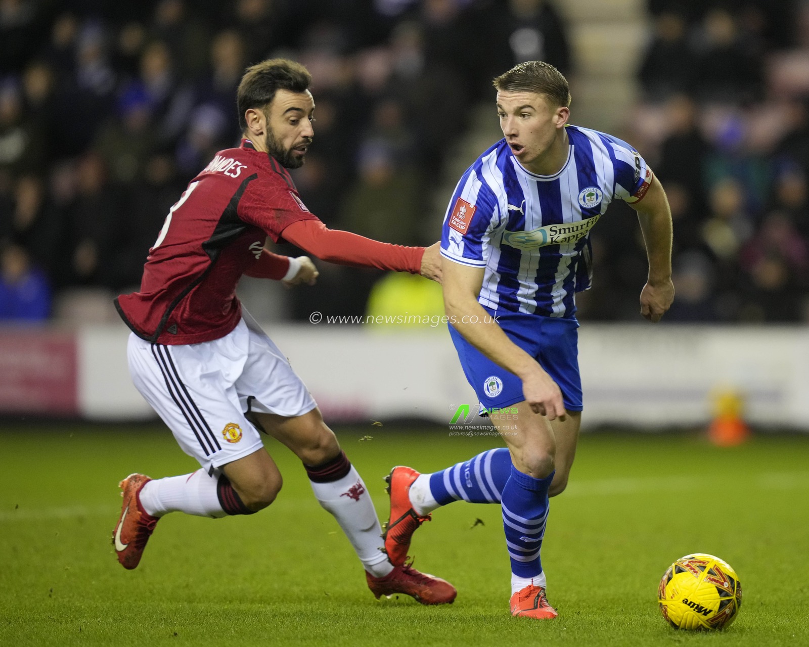 Jason Kerr of Wigan Athletic turns outside Bruno Fernandes of Manchester United during the Emirates FA Cup Third Round match Wigan Athletic vs Manchester United at DW Stadium, Wigan, United Kingdom, 8th January 2024

(Photo by Steve Flynn/News Images)