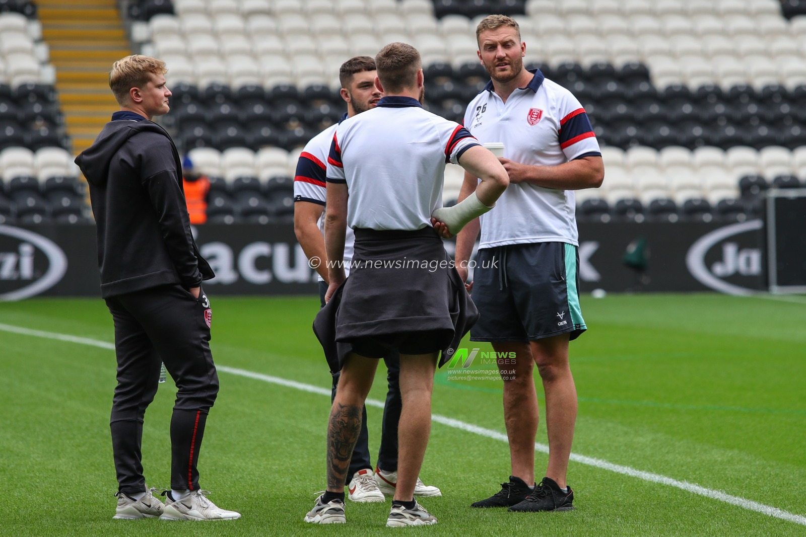 Hull KR players inspect the pitch prior to the kick off