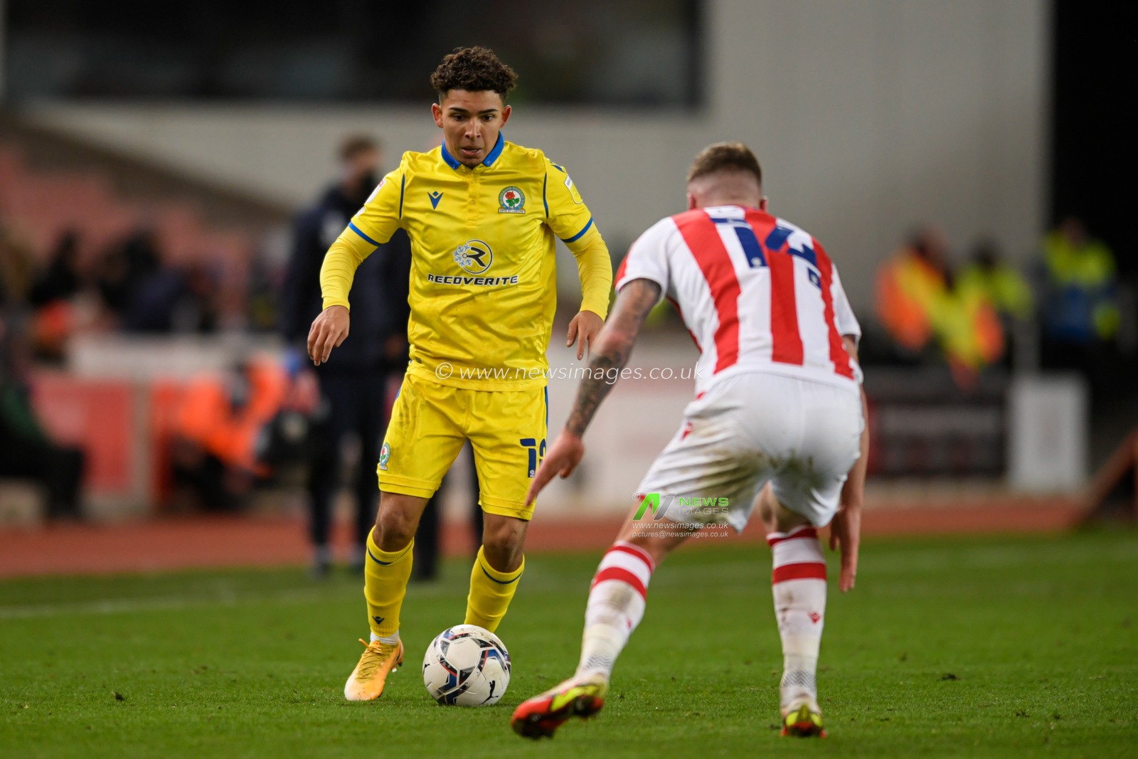 Tyrhys Dolan #10 of Blackburn Rovers looks for a way past Josh Tymon #14 of Stoke City
