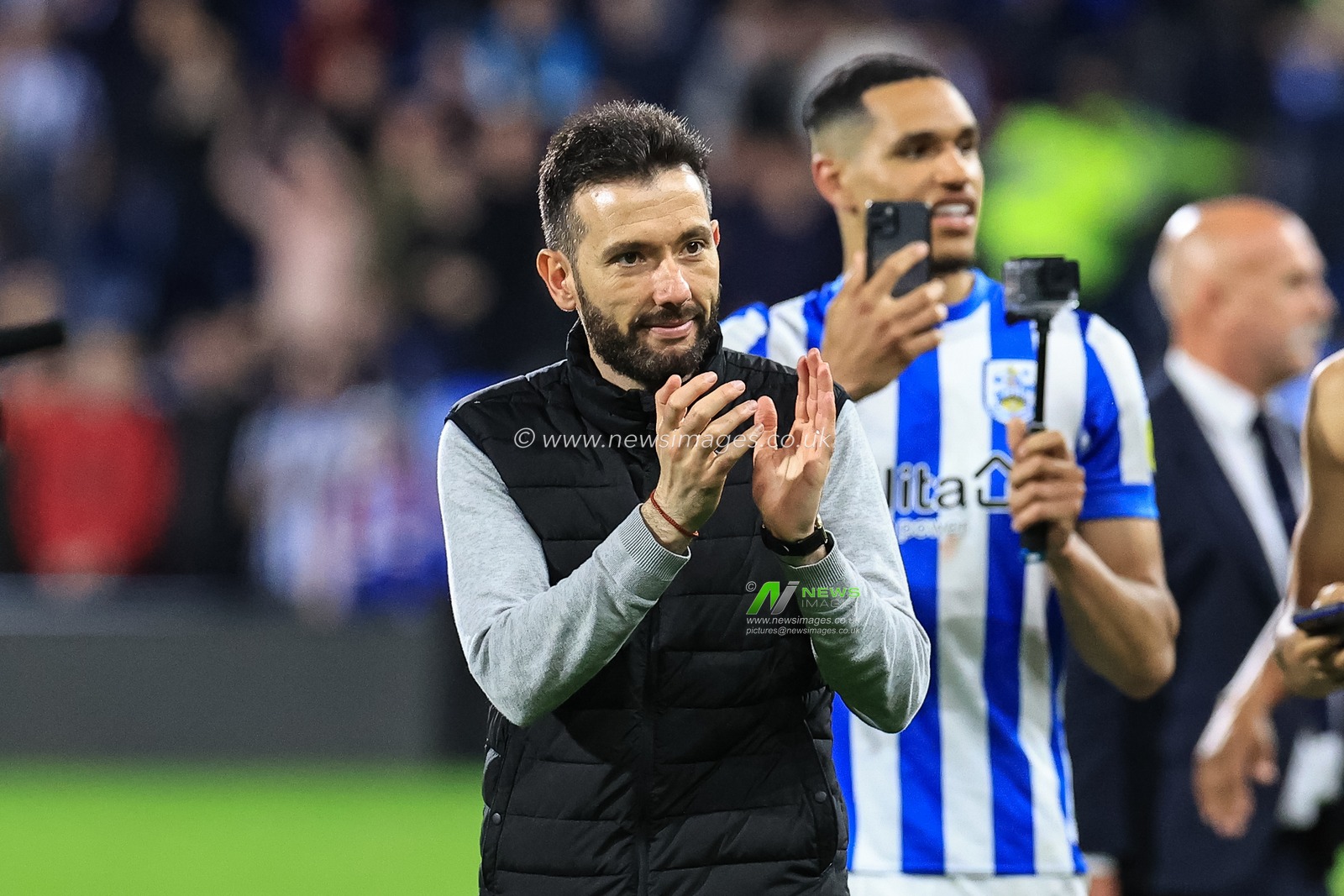 Carlos CorberÃ¡n manager of Huddersfield Town applauds the fans