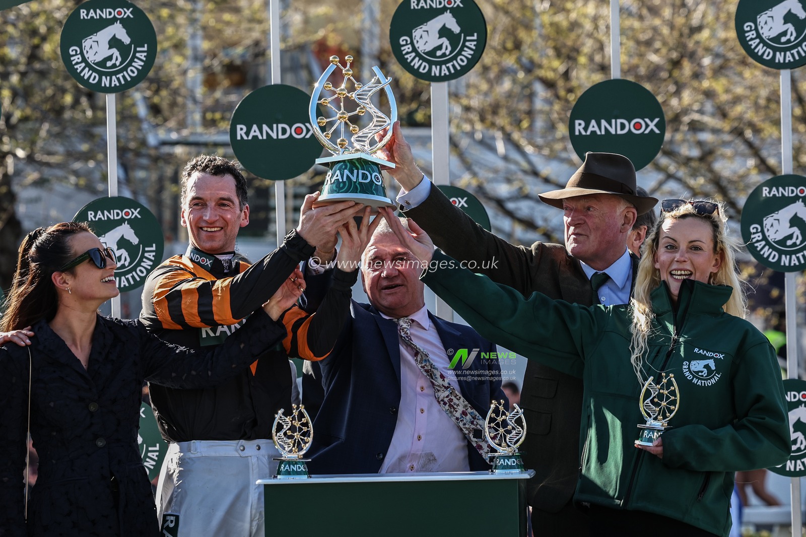 Patrick Mullins, Stewart Andrews and Willie Mullins lift the Grand National Trohpy during the Randox Grand National 2025 Day 3 Grand National Day at Aintree Racecourse, Liverpool, United Kingdom, 5th April 2025

(Photo by Mark Cosgrove/News Images)