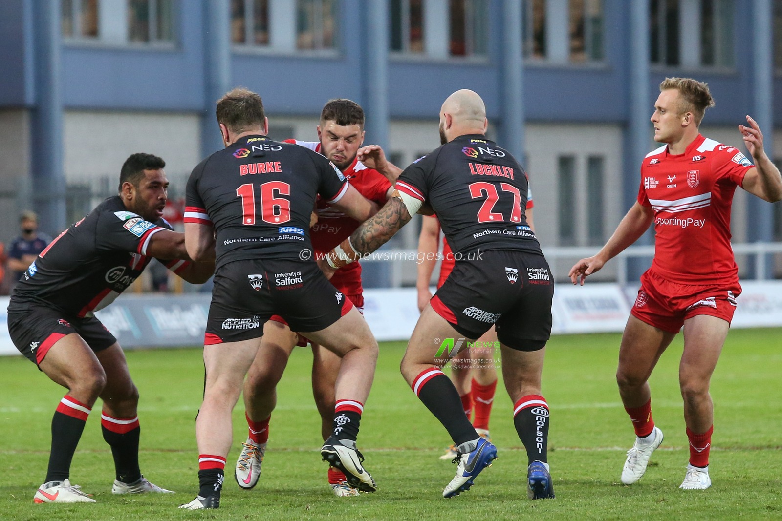 Matty Storton (18) of Hull KR runs at the Salford defence