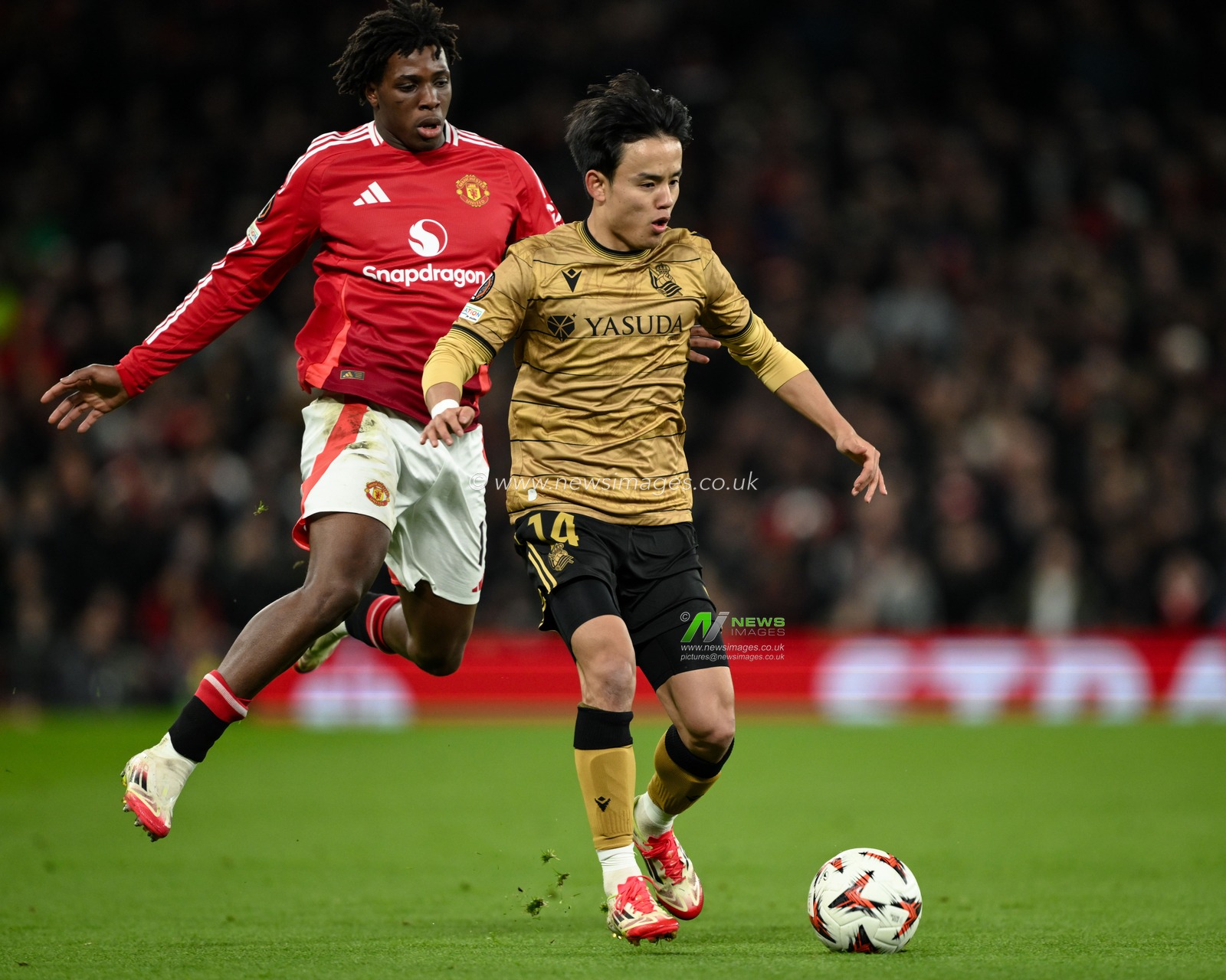 Takefusa Kubo of Real Sociedad breaks past Patrick Dorgu of Manchester United during the UEFA Europa League Last 16 match Manchester United vs Real Sociedad at Old Trafford, Manchester, United Kingdom, 13th March 2025

(Photo by Craig Thomas/News Images)