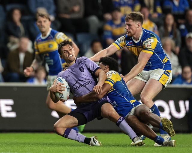 Arthur Mourgue of Hull KR is tackled by Kallum Watkins of Leeds Rhinos during the Betfred Super League round 23 match Leeds Rhinos vs Hull KR at Headingley Stadium, Leeds, United Kingdom, 21st August 2025

(Photo by Mark Cosgrove/News Images)