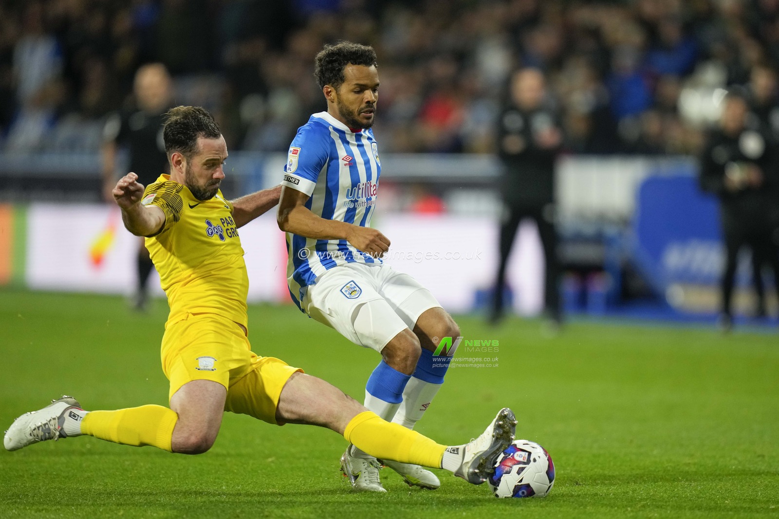 Greg Cunningham #3 of Preston North End slides in to tackle Duane Holmes #19 of Huddersfield Town during the Sky Bet Championship match Huddersfield Town vs Preston North End at John Smith's Stadium, Huddersfield, United Kingdom, 18th October 2022

(Photo by Steve Flynn/News Images)