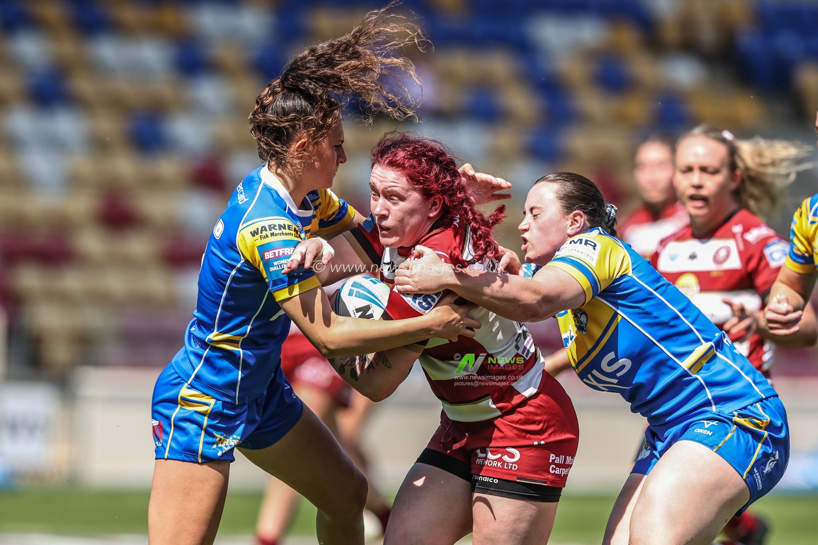 Eva Hunter of Wigan Warriors is tackled during the Betfred Women's Challenge Cup Cup Semi-final match Leeds Rhinos vs Wigan Warriors at LNER Community Stadium, York, United Kingdom, 10th May 2025

(Photo by Alfie Cosgrove/News Images)