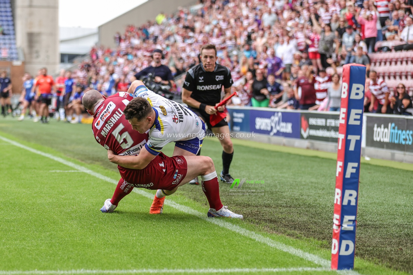 Josh Thewlis #2 of Warrington Wolves takes Liam Marshall #5 of Wigan Warriors out of touch after he heads for the corner during the Betfred Challenge Cup Quarter-Final match Wigan Warriors vs Warrington Wolves at DW Stadium, Wigan, United Kingdom, 18th June 2023

(Photo by Mark Cosgrove/News Images)