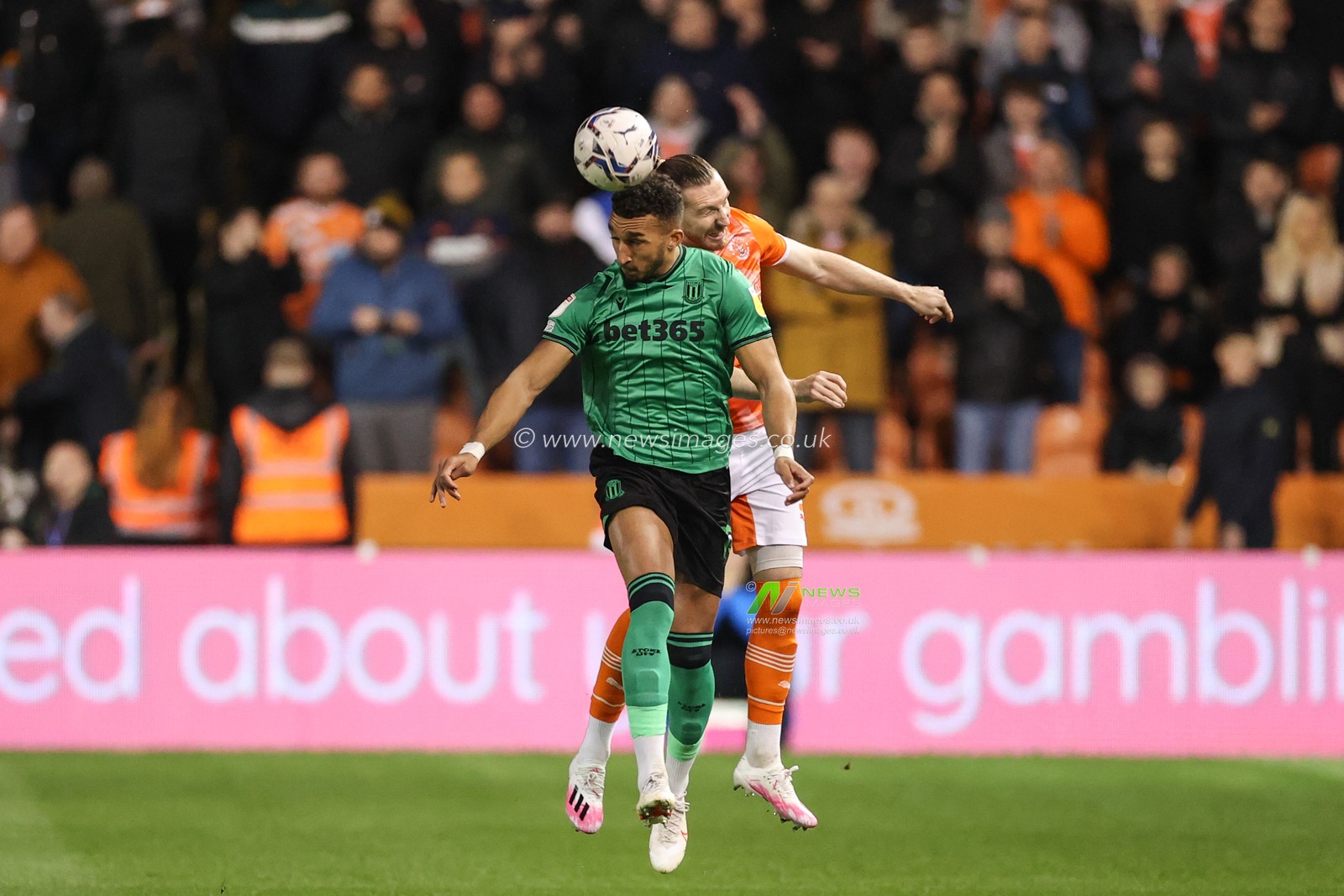 James Husband #3 of Blackpool and Jacob Brown #18 of Stoke City battle for the ball