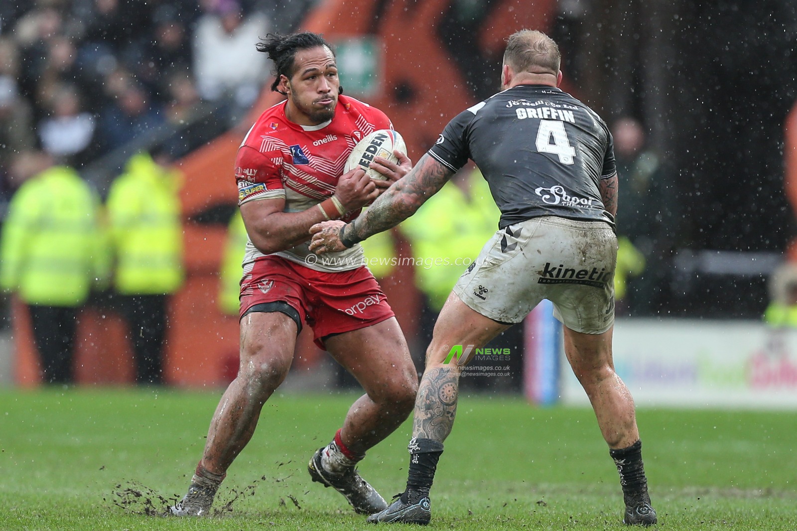 Agnatius Paasi (17) of St Helens runs at Josh Griffin (4) of Hull FC