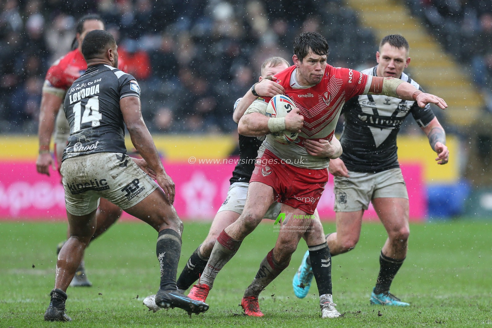 Louie McCarthy-Scarsbrook (15) of St Helens is tackled by Jordan Johnstone (21) of Hull FC