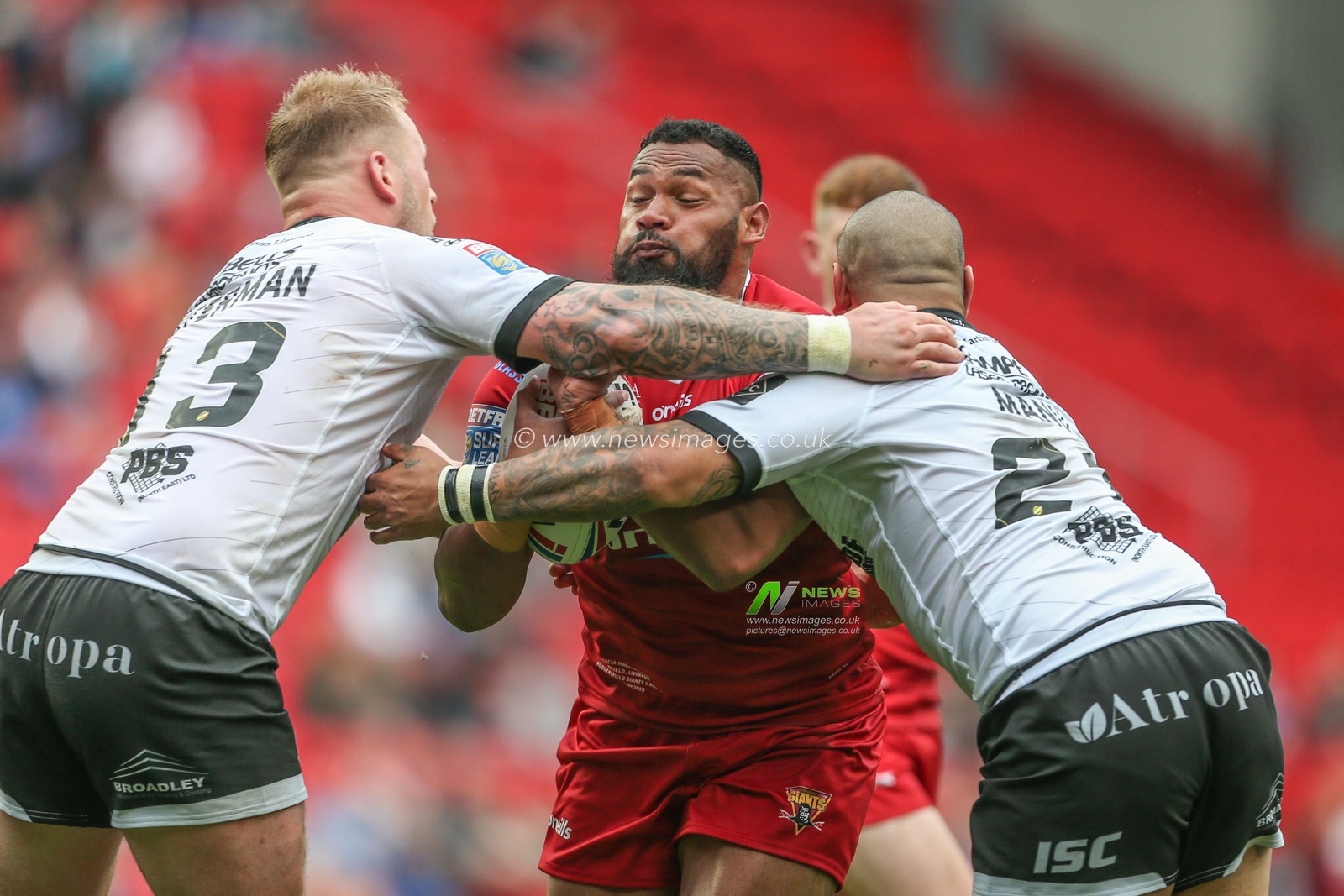 25th May 2019 , Anfield Stadium, Liverpool, England; Dacia Magic Weekend, Betfred Super League Round 16, Hull FC vs Huddersfield Giants ; Ukuma Ta'ai (17) of Huddersfield Giants is tackled by Joe Westerman (13) of Hull FC and Sika Manu (21) of Hull FC 

Credit: Mark Cosgrove/News Images