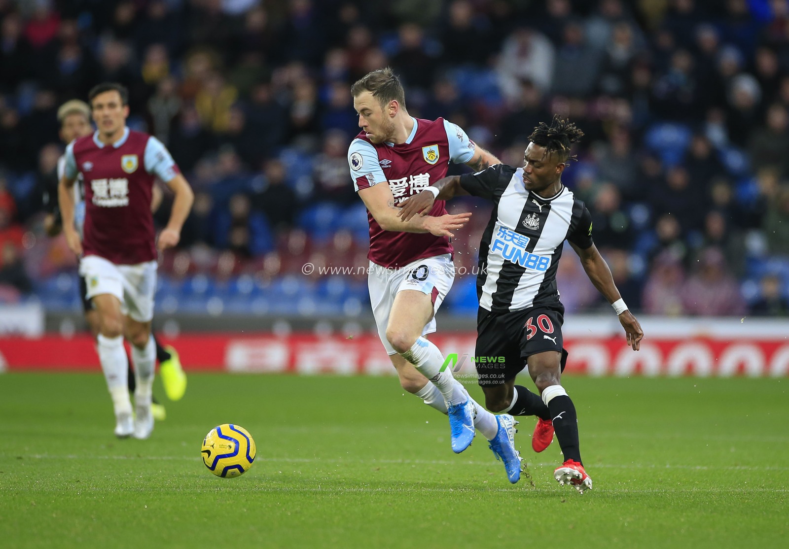 14th December 2019, Turf Moor, Burnley, England; Premier League, Burnley v Newcastle United : Ashley Barnes (10) of Burnley and Christian Atsu (30) of Newcastle United challenge for the ball

Credit: Conor Molloy/News Images